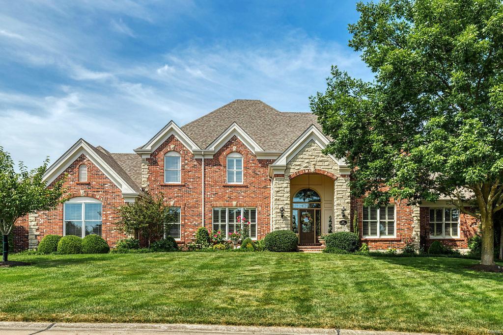 Beautifully designed brick & stone 1.5 Sty! This Maynes-built home features elaborate moldings, soaring ceilings, plantation shutters & oak hardwoods that extend throughout the main floor. Impressive 2-sty slate foyer leads to private study with French doors, coffered dining room and spectacular great room with slate fireplace, wet bar & dramatic wall of windows. Designer kitchen with quartz countertops, 42” white cabinetry, Thermador appliances, 7’ center island & convenient planning center adjoins breakfast room with wide bay window & vaulted hearth room with stone fireplace & atrium door to patio. Main floor master bedroom suite with dimensional ceiling, customized walk-in closet & luxury bath with jetted tub provides an appealing retreat. Front & rear staircases access 3 additional ensuite bedrooms. Lower Level entertainment space includes recreation room, gathering bar & full bath. Situated on a 1+-acre cul-de-sac lot with 2 patios with pergolas, landscaped gardens & 3-car garage.