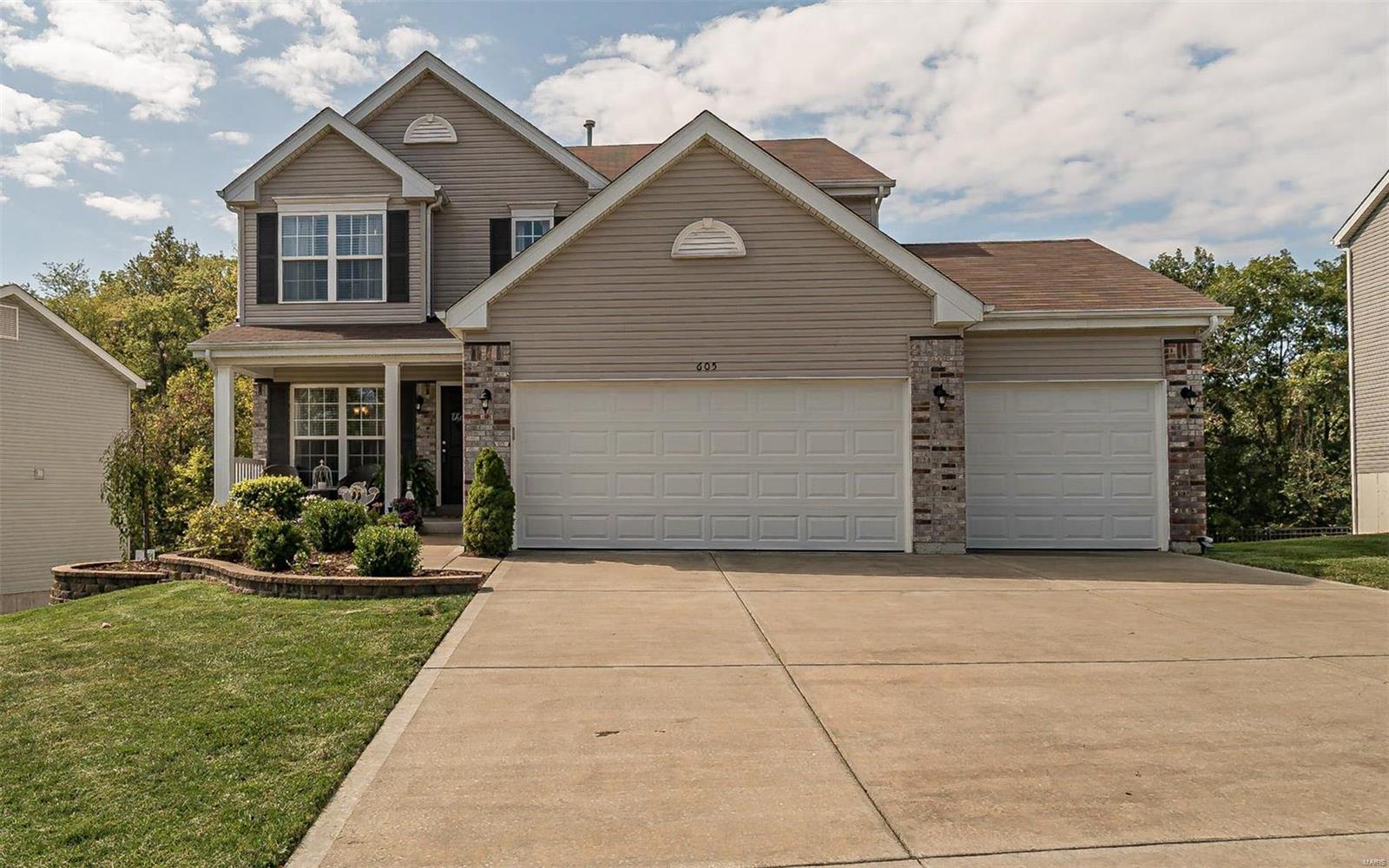 Super 2 Story. Great curb appeal. Professionally landscaped with beautifully tiered walls, large covered front porch and an oversize 3 car garage which was extended on one side. Enjoy the clean lines and lots of windows for natural light. Hardwood in foyer, kitchen and breakfast area. Kitchen has a center island with lots of custom cabinetry plus features like crown moldings, glass door corner cabinets, staggered heights and a beautiful tile back splash. Double door pantry. Main floor laundry. Upstairs is a great sitting/tv area. Huge master bedroom with 2 closets, a luxury bath with double sink, a corner tub with window overlooking woods, plus a glass shower. Hall bath also has a double sink plus a transom window. There are sliding doors off the breakfast area to a super private deck with an Arbor that overlooks woods. Steps lead from the large deck to a patio off the walk out lower level. Chrome handles hinges and bath plumbing fixtures! Hurry this gem will not last!