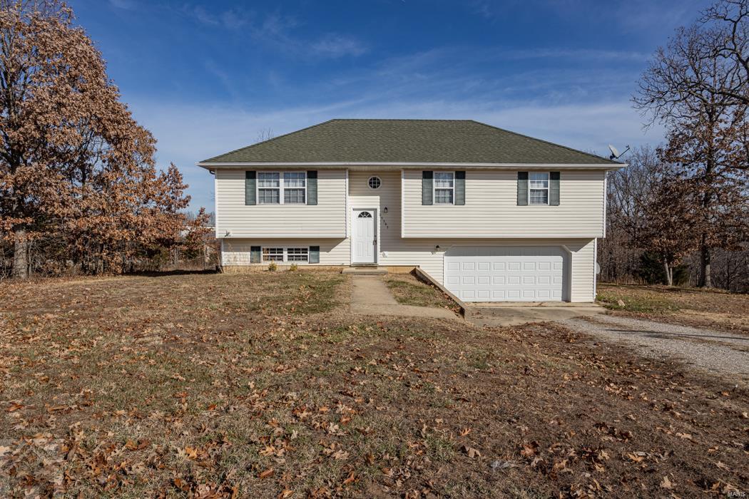 Are you looking for an affordable MOVE IN ready 3 bedroom, 2 bath home that is close to Fort Leonard Wood & in the Waynesville school district? This is it! This freshly cleaned split foyer home features an unfinished basement, two car garage, great yard & more! Enjoy the peaceful view off the back deck with no neighbors in sight behind you. The living room has carpet flooring, ceiling fan, and it's layout is open to the dining/kitchen area. The kitchen features beautiful light oak cabinetry, laminate countertops, white appliances and vinyl flooring for easy clean up. The spacious master bedroom ensuite styles grey carpeting, ceiling fan, closet, single vanity, and shower/tub combo. Two guest bedrooms and a full guest bathroom are also located just down the hall. Downstairs is the unfinished basement that you can finish to your liking! The laundry room hookups are also located downstairs. Home and carpets have been professionally cleaned, move in ready! Schedule your showing today!