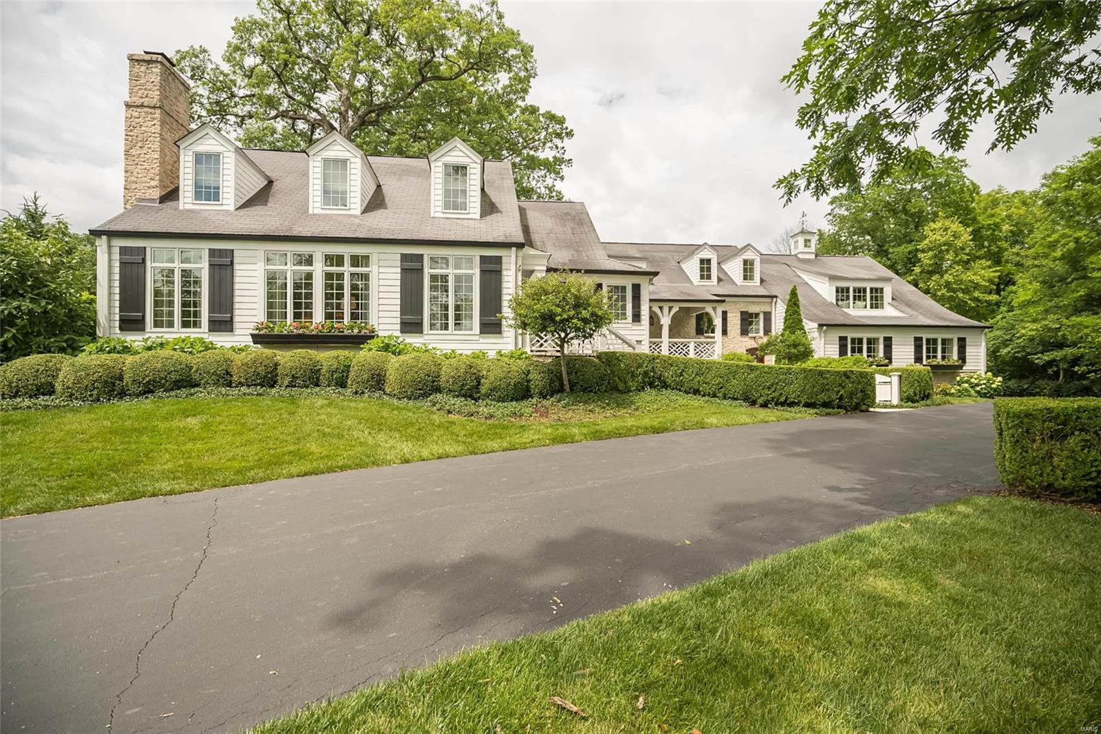 On top of a hill on a lush 2.32 acre lot, this charming 1.5 story was expanded in 2008 to create a floor plan with today's
lifestyle in mind.Embracing refined style and casual comfort with exceptional finishes throughout, the 4 bedroom, 3.5 bath home offers views of #8 on Old Warson CC. The cozy living room steps down from an awesome bar, study/office and dining room. The chef's kitchen has custom cabinets & high end appliances, walk in pantry that open to the vaulted ceiling Great Room with stone FP, built in desk and breakfast room with access to the spectacular screen porch with outdoor bar and darling potting shed. The main floor primary bedroom suite offers a FP, luxurious bath and closet. Spacious main laundry, huge playroom/family room with daybed and built-ins and 2 powder rooms. Upstairs are 3 bedrooms and 2 baths. Outdoor stone fireplace and pool lead to the adorable guest cottage w/FR /FP, full kitchen, dining, bedroom, laundry and 1.5 baths. 3 car oversized garage and more