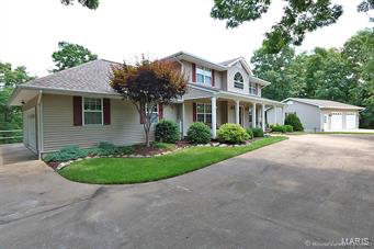 Custom 2 story home situated on almost 4 acres in Hillsboro School District includes a 34 x 26 detached garage/workshop that is heated and wired for a compressor - the perfect "MAN CAVE". Circle driveway highlights the beautiful landscaping throughout the property. 4 bedrooms and 3 1/2 bath. Separate dining room. Great room hosts built in shelves & wood burning fireplace. Gourmet kitchen with breakfast bar, newer Bosch dishwasher, planning desk & adjoining breakfast room. Your family will love the outdoor living space in the 26 x 12 screened in porch overlooking the park like setting yard, sure to see deer & turkey. The upper level includes luxury master suite with 2 large walk in closets & spa like bath. Two additional large bedrooms, full bath & bonus room. Finished lower level offering recreation room, bedroom, full bath & large mud/laundry area. Excellent location just minutes from highway and schools. Pride of ownership shows throughout!
