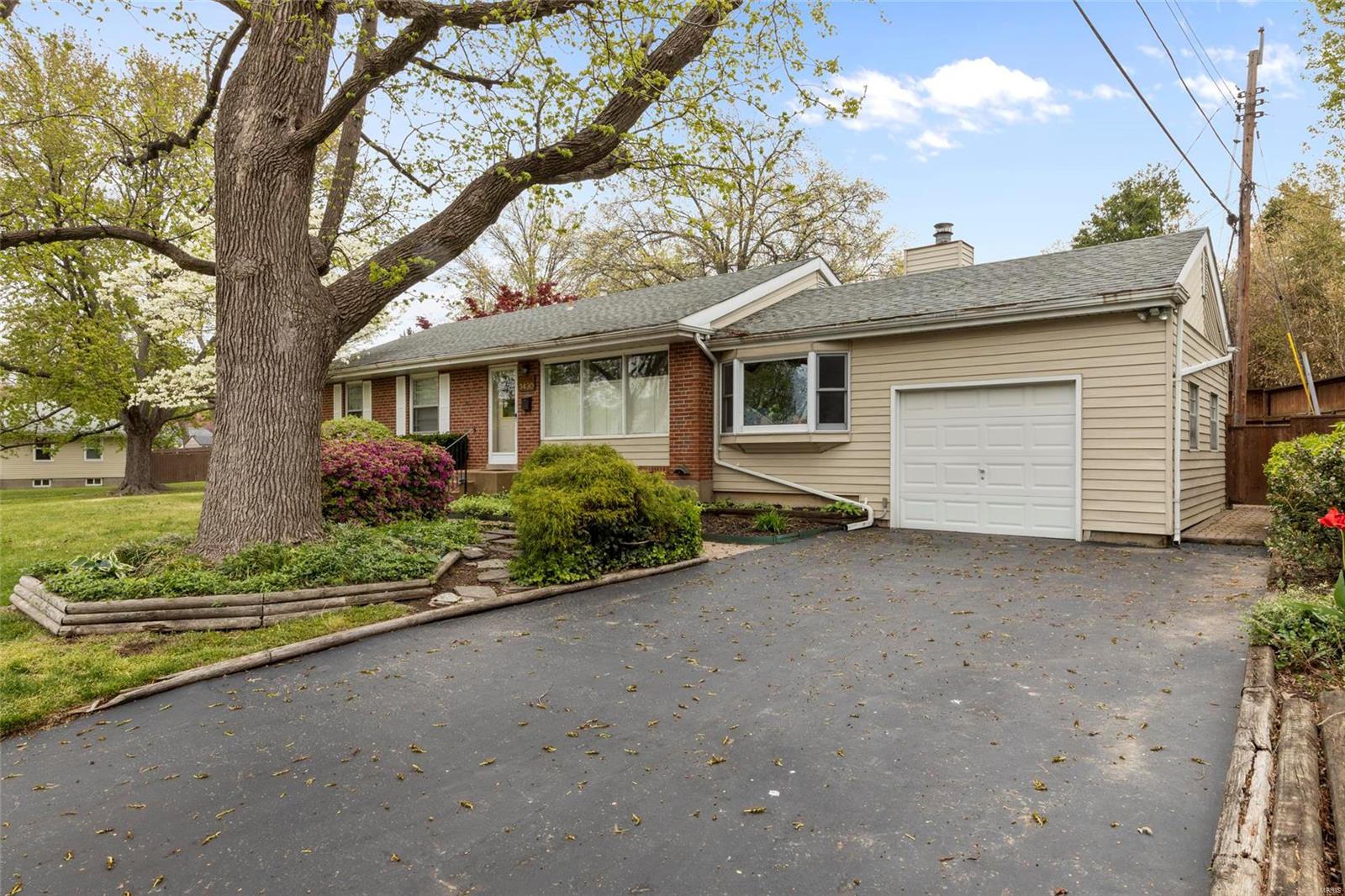 Welcome home to this darling brick ranch on a lovely tree-lined street.  Inside, you'll find a spacious open floorplan with a large living room that flows into a nicely appointed kitchen and adjoining dining area. You'll love the custom wooden cabinets, tons of counter space, large island with seating, and stainless steel appliances. Off the kitchen area you'll step down into a great sunken den with a fireplace and tons of natural light! At the opposite end of the home, you'll find a nice-sized master, full bath with skylight, and 2 more cute bedrooms. The LL is full of custom finishes, including an impressive wooden wet bar which is perfect for entertaining! The LL also has a spacious rec room, full bath, a sleeping area/office, and plenty of storage/workshop/utility space. In the back, you'll be charmed by a cozy private courtyard! Upgrades include HVAC (approx. 2016), updated electrical panel, plumbing stack, and more! Property to be sold in AS-IS condition.