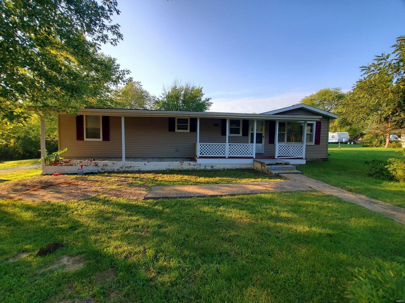 So much opportunity here!  This 4-bed, 1.5-bath ranch style home offers a sunny interior, spacious room, a divided bedroom floor plan, covered front porch, and a private back deck overlooking the shaded yard.  You’ll appreciate this location on the east edge of New London, and an added bonus is the 5.12 acres m/l that sell with the house!  In addition to the house tract, this includes a 8,663 sq ft corner lot, and 4.4 wooded acres with a small branch meandering through it.  Escape here for mushroom hunting, wildlife & more.  The home includes an open floor plan, spacious living/dining/kitchen area, and big bedrooms.  The laundry room offers plenty of shelving & storage space, and a handy back mudroom off the back deck is the perfect storage spot for coats & shoes.

Utility providers here include Ameren electric & gas, City of New London water & sewer, and there are several options for trash & Fiber Internet. This is a quick drive to Hannibal, or 1.5 hours to St. Louis, MO. Additional Rooms: Mud Room