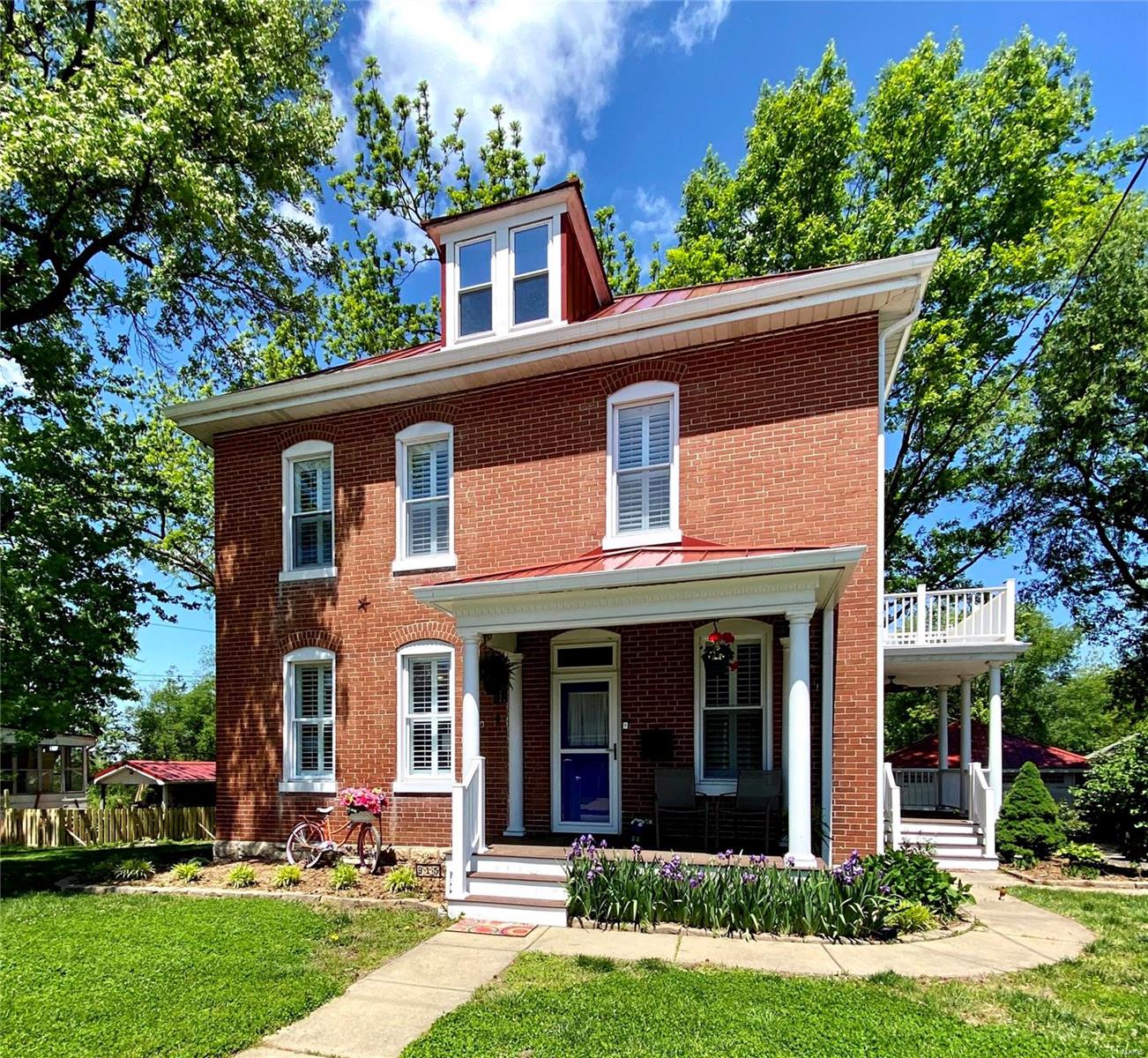 Beautifully renovated, stately 3 story brick turn of the century home with large, gracious living and dining rooms that encourage entertaining. Updated kitchen with solid surface counters, new dishwasher, recessed refrigerator, and a butcher block coffee/wine bar with a wine cooler. You will fall in love with the refinished hardwood stairs and floors. Escape to the Master Bedroom suite with walk-in closet, soaker tub, laundry area and a walkout to the upper balcony. The 3rd story is a spectacular, light filled room with vaulted ceilings that can be used as an entertaining space, library or office. Outdoor storage abounds with an over-sized 2 car garage (22 x 34) and storage shed. This spacious home sits on almost half an acre and has room for all. Enjoy coffee on the 2 main floor porches or patio or walk to nearby restaurants, stores, park and the river.
