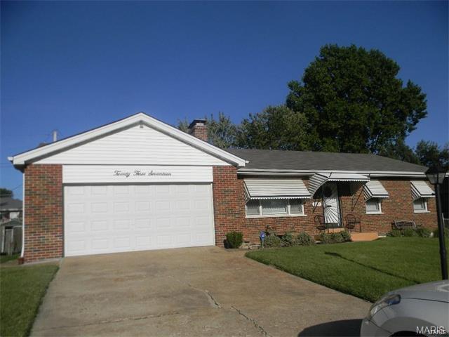 Spacious three bedroom Ranch style home with finished lower level located in a mature, established neighborhood.  This home has maintenance free brick exterior and a two car attached garage.  The interior has the original hardwood floors throughout and has been freshly painted.  The main floor bathroom tiles and tub have been freshly re-glazed. You'll love the retro cabinets and counter top in the kitchen with large pantry and updated flooring.  The backyard is perfect for barbecuing or simply relaxing. This home is ready for move in. Close to everything...schools, shopping, restaurants and highways.  Just minutes from Lambert Airport and Downtown St Louis attractions!