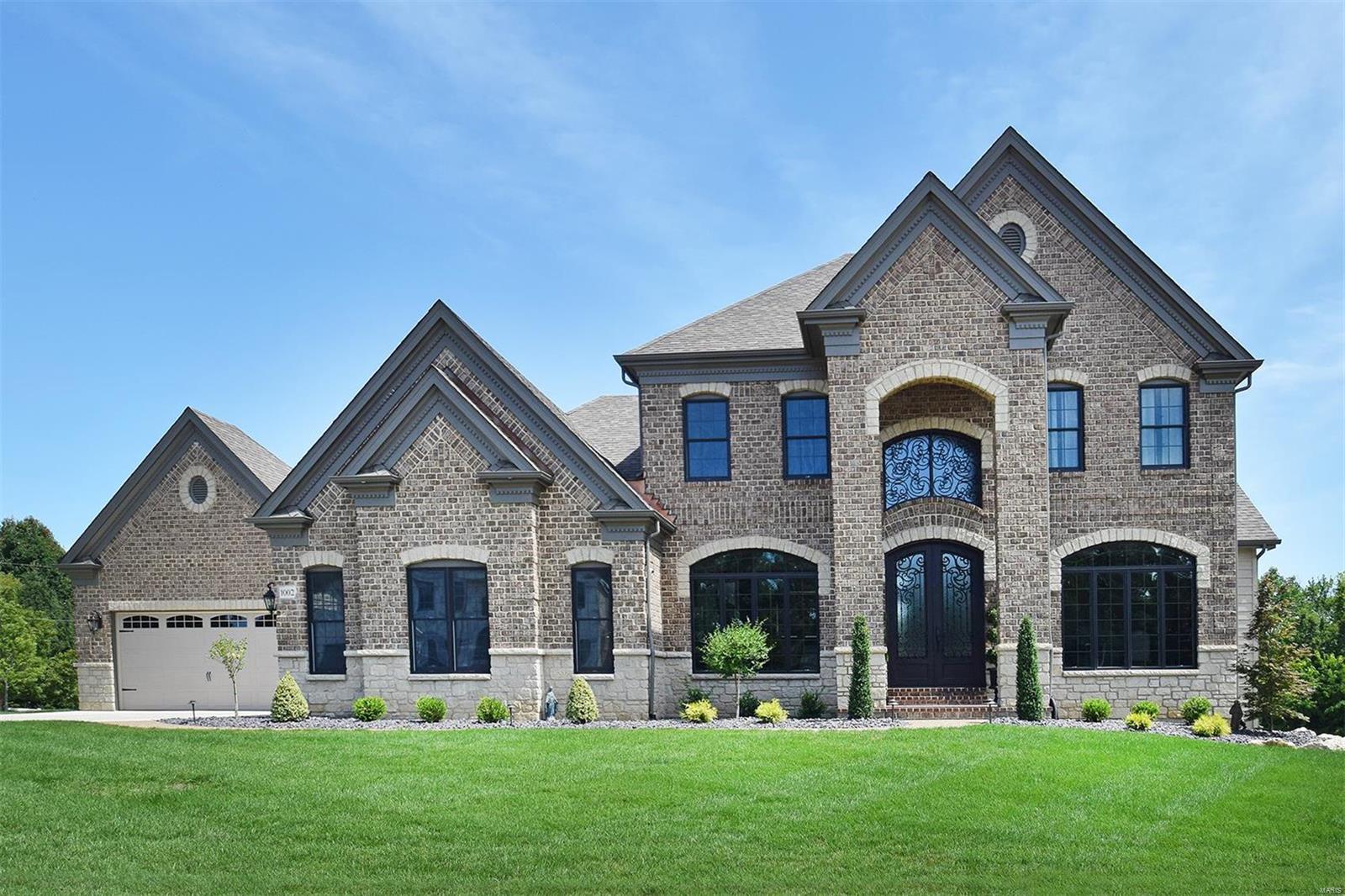 You can get brand new, right now? This incredible Claymont Development Wingate III display home is appointed with the highest quality finishes and extra options, and presented in perfect condition.  This 5 bed 4.5 bath 1.5 Story masterpiece has a terrific floor plan with loads of top-of-the-line lighting, extensive mill-work, hardwood and marble floors throughout, 2- Story windows, custom closets, etc. etc. A huge office and a Great/Living Room with a 2-Story stone fireplace and custom shelves, a Kitchen with every luxury, and a master suite that will blow you away. Upstairs are 3 additional large bedrooms and two full baths. The walk-out Lower Level will blow your mind with its engineered hardwood floors, a theater room, game room, fifth bedroom and a fantastic wet bar. Take note of the 4 Car Garage! Outside is the covered patio, a very cozy screened porch, and low voltage lighting. This masterpiece sits on the most desirable lot in the neighborhood with easy access to everything.