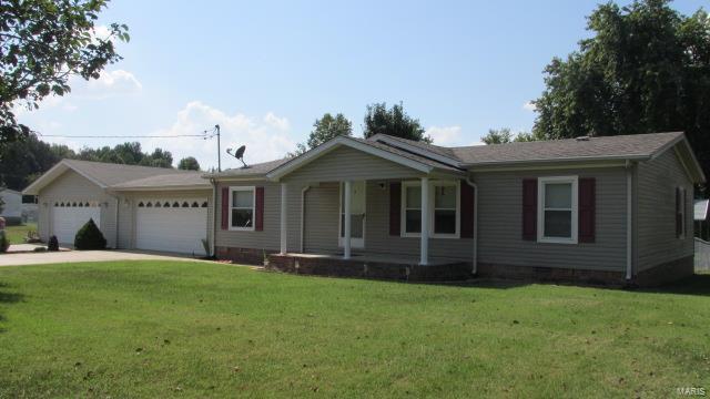 Very well maintained home right outside city limits. Located on 1 acre lot M/L. Three bedrooms and two baths. Large living room with vaulted ceiling and gas fireplace. Large walk-in closet in master bedroom. Chained link fenced in area in back yard with large covered patio. Lots of beautiful trees on property. Large attached garages will hold 4 cars or a place to store your boat.