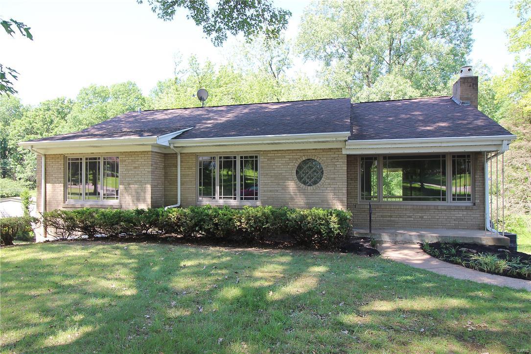 Charming 3 bedroom, 2 bath with 2 car garage Ranch home in sought after St. Louis Hills Estates. Just a short distance from both Willmore Park and Francis park. Entertain your guests in the large Living room/Dining room with wood floors and gas fireplace. French doors off Dining room to a sun room with large windows overlooking open ground to Willmore Park. Enjoy the mid-century retro look eat in Kitchen - add your decorating touches. The master bedroom has wood floors, 2 closets. Two additional bedrooms and 2 baths on the main level. Walk out lower level with large windows great for Rec room. Updates to large patio, freshly painted interior 5/17, newer carpet, Lower level, updated windows and leaded glass exterior door.