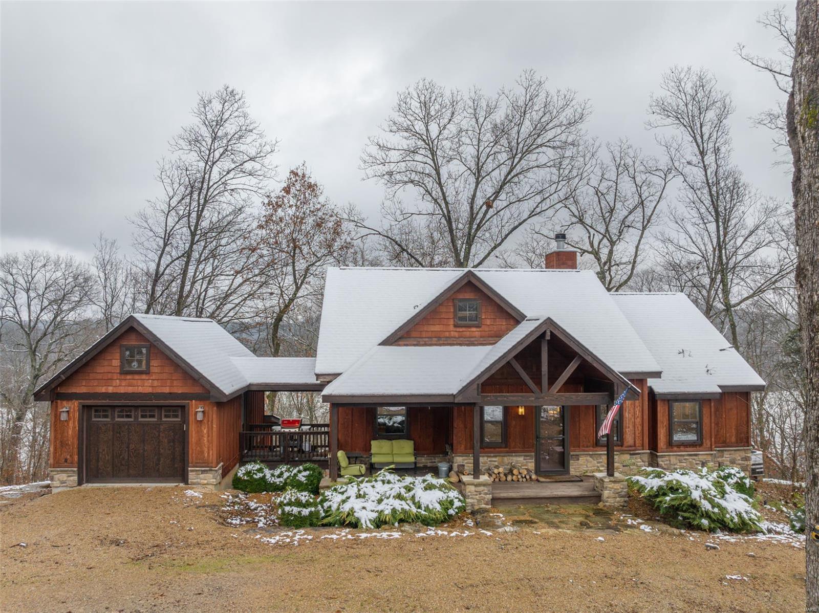 Move in ready most furniture is included. Incredibly private cottage nestled on five acres of gorgeous hardwoods, loaded with bells and whistles.  The perfect weekend retreat or year-round home. The large front porch is perfect for morning coffee. The luxury kitchen, complete with granite tops, large center island, custom cabinets, opens to the great room, which features a large stone fireplace. tongue and  groove cedar vaulted ceilings! The main floor has a spacious master suite and the lower level has two additional master suites. Each bathroom is finished with tile surrounds, custom cabinetry and granite tops. The back covered deck, with its own separate stone fireplace, is idyllic for entertaining friends, watching the game or snuggling up with a good book. The views overlooking the valley are tremendous.  Go for a hike on the bordering nature trail. Around the corner from Alpine Lake and close to Kitsbuhl Beach area.