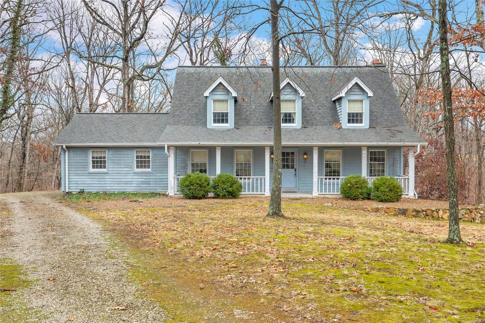 A rare opportunity to have six private wooded acres & a home that is move ready home in the Defiance zip code for this price. No restrictions-bring your chickens & county approved animals. Being sold "AS IS" but built to last & solid as a rock, this home has good bones & the warmth of an old fashioned country home. Spacious Kitchen with tons of cabinets, Corian counter tops, all kitchen appliances included as well as washer, dryer & freezer. Walk out to the large composite wood deck from the breakfast bay & overlook this wooded paradise. The family room has a 5 window bay $ beautiful custom book cases flanking the full masonry fireplace & the accent wall in the lower level walk out basement which has a  rec room and full bath. Exit to large patio & pottery shed for all of you gardening needs. Three bedrooms, two full baths & a small loft area for your treasures or small study area are featured upstairs.  Francis Howell Schools, Broemmelsiek Park & Augusta Wine Country near by. HURRY!