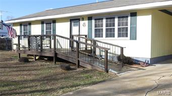 Updated, comfortable, clean, and move in ready! 3 BR, 1 1/2 BA Ranch style home on .34 acre offers a spacious and bright living room, dining room and kitchen combo with pantry, trendy white wood cabinets and white appliances, MBR suite. A perfectly located utility/ mudroom leads to a 2 car attached covered carport. Washer and dryer included! A partially finished sunroom off the dining room leads to a wood deck for extra space to entertain and a large fenced back yard that has a wood privacy fence and chain link fence that allows views of an adjoining open pasture. The exterior has newer vinyl windows, a beautiful wood front porch entry, and a combination of painted and stained wood and half log siding. Propane furnace with electric baseboard back up. Newer water heater. Additional Rooms: Mud Room, Sun Room