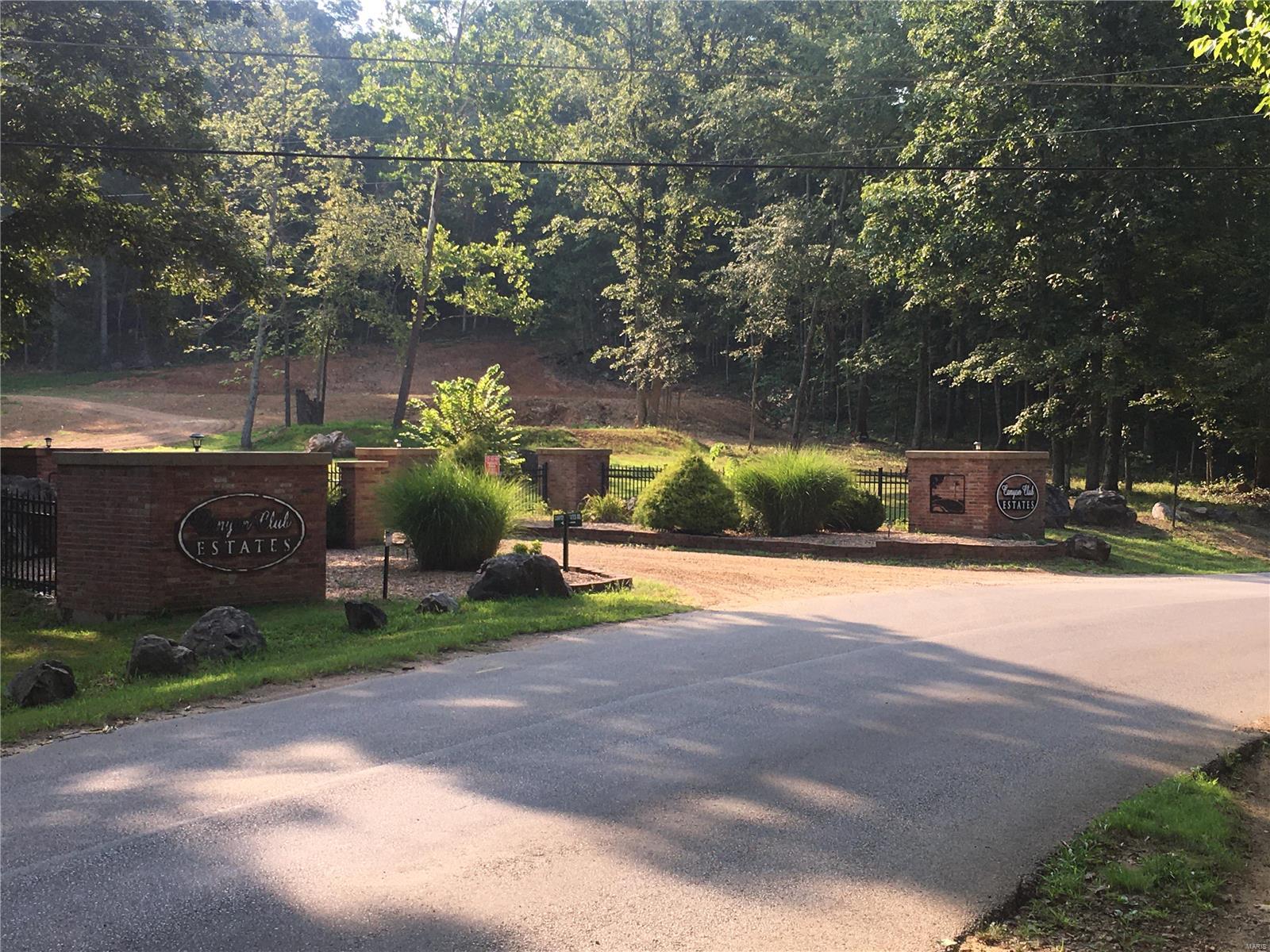 Wooded 12.22 acres, Lots 20 and 21 of Canyon Club Estates. Electric runs along the gravel road and also city water hookup. Access to back Lot #20 from lane at end of property. Great place to build your new house with privacy but near town. Some restrictions.