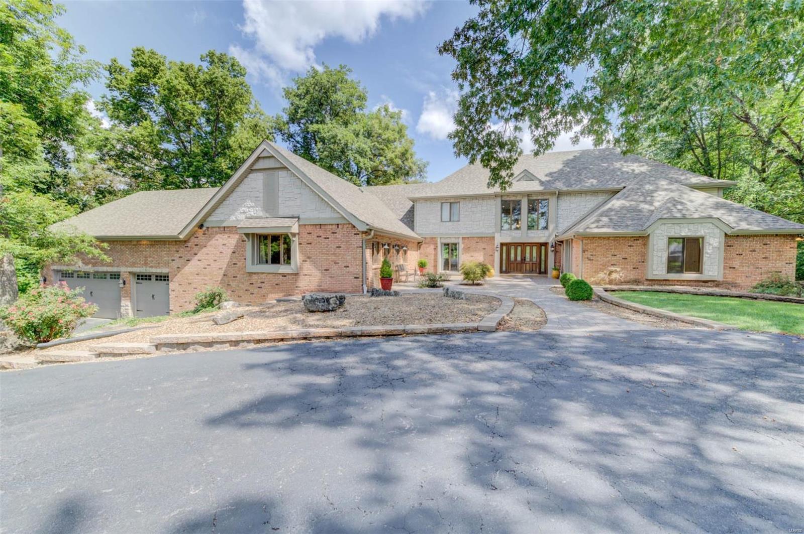 WATERFRONT Estate on private 1.8 ACRES. SPACIOUS 1.5 story residence w/open floorplan & gorgeous updates. Majestic 2 story entry w/views of iron spindled stairway & balcony, elegant sunken living room & the scenic wooded lot beyond. Lots of beautiful WOOD & marble floors. 5 bedrooms, 2 up & 3 on the main level w/a possible master on both levels. The impressive kitchen & hearth room combo w/soaring vaults must be seen to be appreciated! Formal dining room, huge family room & upper-level theatre room. Walkout L/L is beautifully finished offering large rec room w/fireplace, wet bar & exercise room. Screened in porch & 2 levels of decking overlook attractive inground POOL w/pool house & wooded lot that leads to your private DOCK on the large lake. LSLCA Amenities. Did I mention the tandem garage that could house 5 or 6 vehicles? Association fees are $150/yr. to Timberlaine Trails and $600/yr. to LSL Community Association. This home is truly one-of-a-kind!