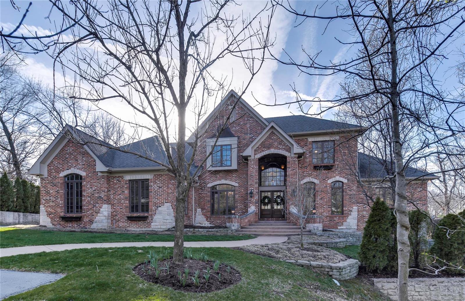 This stunning 12 year old Ladue home meets a designers definition of "Tasteful, Quality Finishes Through-out". This showcase offers 5 luxury bedrms & 6.5 baths. 6,285 total sq. ft., of finished spaces and is complimented w/technological features galore. The 1st fl  meets today's needs w/an amazing Master & Master Bathrm, a chef's gourmet Kitchen, Breakfast Area, Hearth Rm, Great Rm, Office/Study, Dining Rm, Laundry Rm & Mud Rm. The 2nd fl accessed by a rear staircase has a Library/Loft w/great natural light & 3 bedrm suites. The LL is the "Signature" area w/3 rec areas, a theatre like you've never seen, a stone gas fp, a large temperature controlled wine rm, large bar area, a bathrm w/a full steam and full sauna and a 5th bedrm suite w/a bath area offering accessible wheel or walk-n shower. The back was selected by St. Louis Magazine for it's award winning hardscape, pool, bocce court, large arbor, patio & a lower patio area w/a large stone fp & LL walk-out. 3 Car oversized garage. Some Accessible Features Additional Rooms: Mud Room, Sun Room
