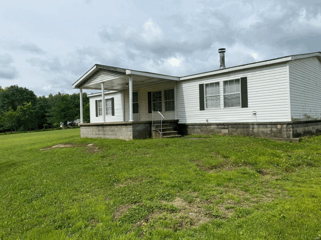 This 3 bed/2 bath vinyl siding mobile home situated on 3 acres, front desk, back deck, old barn, and shed with electric. Home features a fireplace, garden tub and open concept. Home needs work.