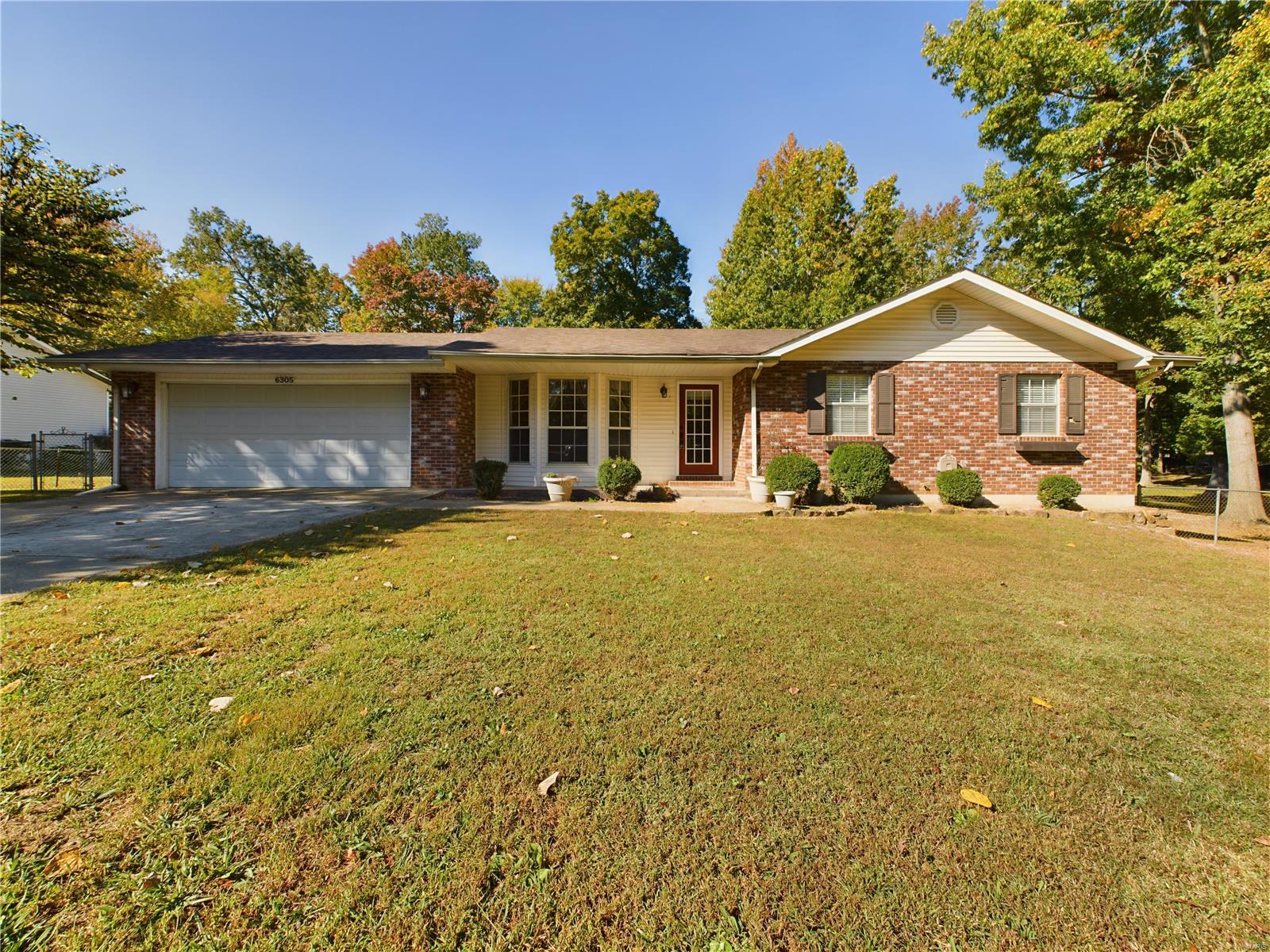6305 Pinecrest Drive, Poplar Bluff, MO- Large 3/4 bedroom brick and vinyl raised ranch home for sale just West of town under mature shade trees on approx. 1 acre! The large yard is fully fenced with a detached garage / workshop, offering ample room for outdoor activities. Upon entry you are greeted by an open living area and upgraded kitchen featuring real hardwood flooring and ample custom cabinetry. A large living room with LP fireplace and generous windows leads through a four-seasons porch / office and finally outside to the huge back yard. The bathrooms have been upgraded with stone countertops and newer fixtures are found throughout the home. There's a partial basement that is finished and serves as BR4 / game room / flex space. Back outside to the workshop, you'll be pleased to find additional utility hookups in place should you wish to build a larger shop or RV shed, etc. You are certain to enjoy the quiet and relaxing setting while enjoying the convenience's of town nearby.