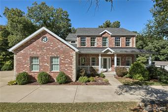 2 MIN from WILDWOOD, this home tucked on 1.39 acres & 3 car garage! 4 bdrm, 2.5 bath, 3000 sq ft. Custom glass front door centered on the wrap around porch. Hardwood floors lead you through the dining room that has a sculptured ceiling. What a beautiful kitchen! Granite countertops, 42" custom hickory cabinets, downdraft cooktop, center island. While standing at your deep black granite sink, you can overlook the woods. Pantry & main floor laundry are all there! Family room is separated from the kitchen with a small breakfast area w/bay window leading to the cedar deck. Gas fpl has brick surround & flanked with wood bookcases. Finish the main level with the living room that is flooded with natural light. Upper level has 4 large bedrooms including the master suite w/vaulted ceiling. The Mstr Suite has gorgeous counters, lots of natural light, travertine step up jetted tub & separate dual head shower! And a huge walk in closet. LL is a tall pour , walk out! Zoned heating/cooling!