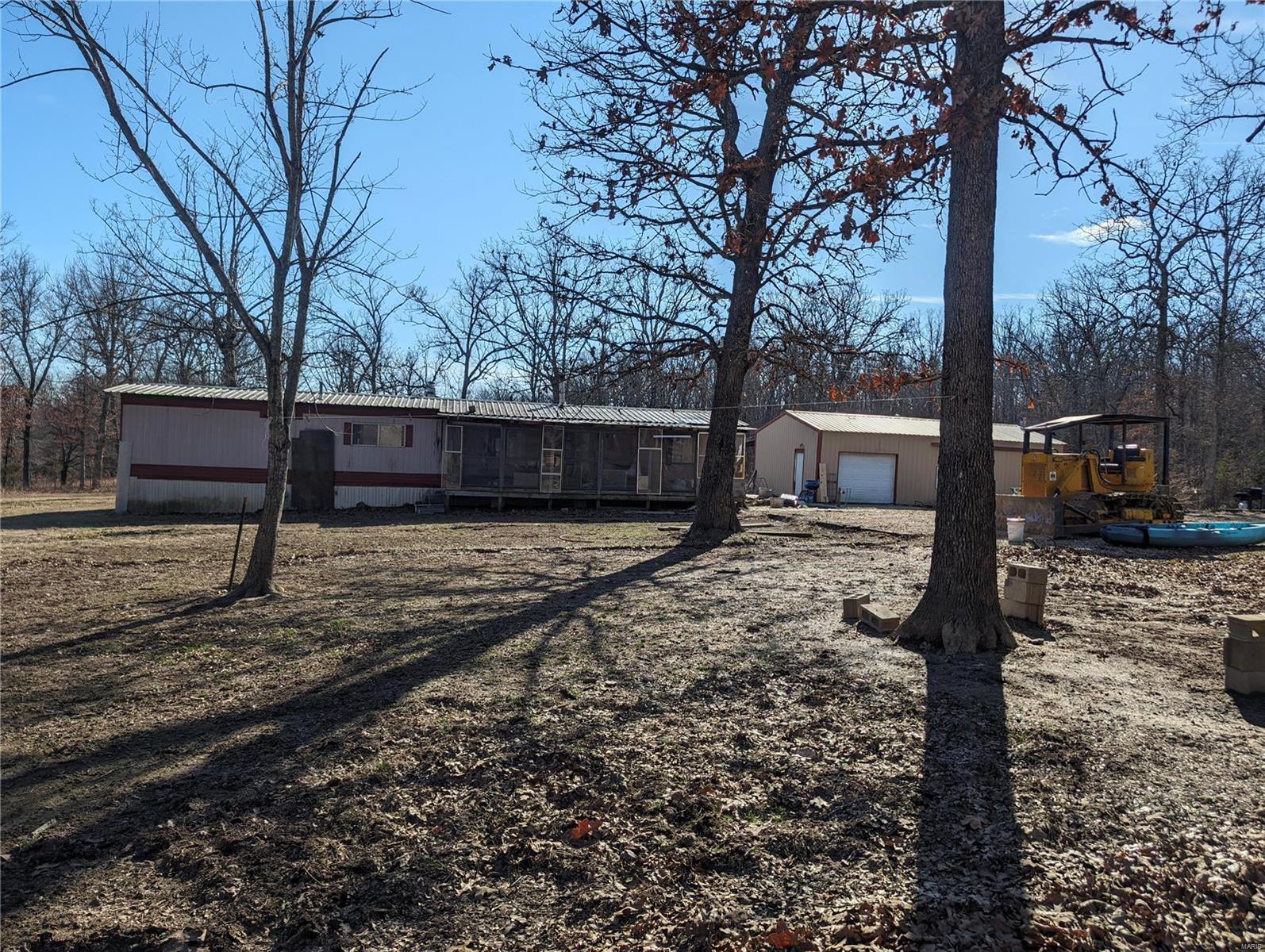This beautiful 5+ acre property is ready for you to build your dream home! this property offers a pond AND a shop ready to go with it's own utilities. There are also outbuildings to start your hobby farm.