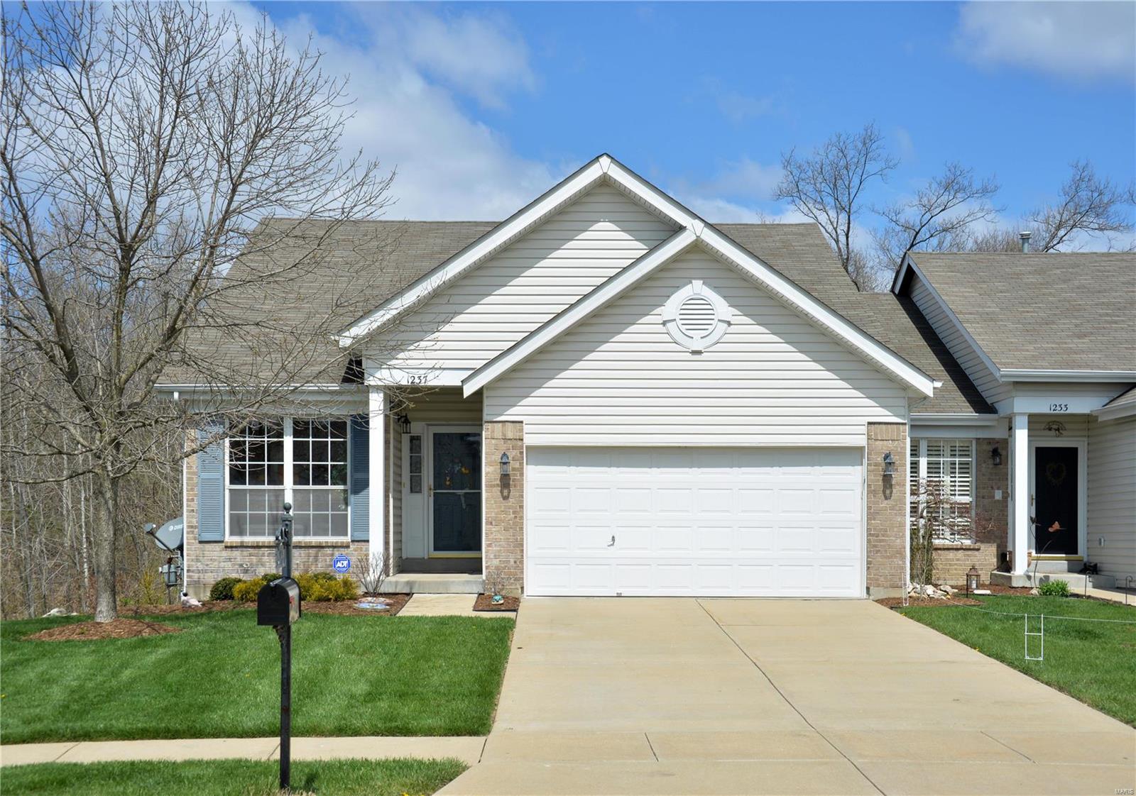 West County Walk-out Ranch/Villa with 3 bedrooms, 3 full baths and 2-car garage.  Main level features open floor plan with Carpeted Living Room with vaulted ceiling, ceiling fan and arched window; Kitchen with hardwood flooring, raised panel cabinets, breakfast room with bay access to large deck overlooking lawn backing to wooded common ground, main floor laundry, main floor master bedroom suite with bay window, vaulted ceiling, ceiling fan and full bath with double vanity and large glass shower, 2nd bedroom and full bath with Jacuzzi tub in hall;  Open staircase leads to lower level with 3rd bedroom with walk-in closet, Jack and Jill Bath, storage area, and family room with ceiling fan and walk-out to yard.  Additional amenities include drywalled 2-car garage and sprinkler system.  All of this in the Rockwood School District and close to Restaurants, Shopping, Parks and Historic downtown Eureka.