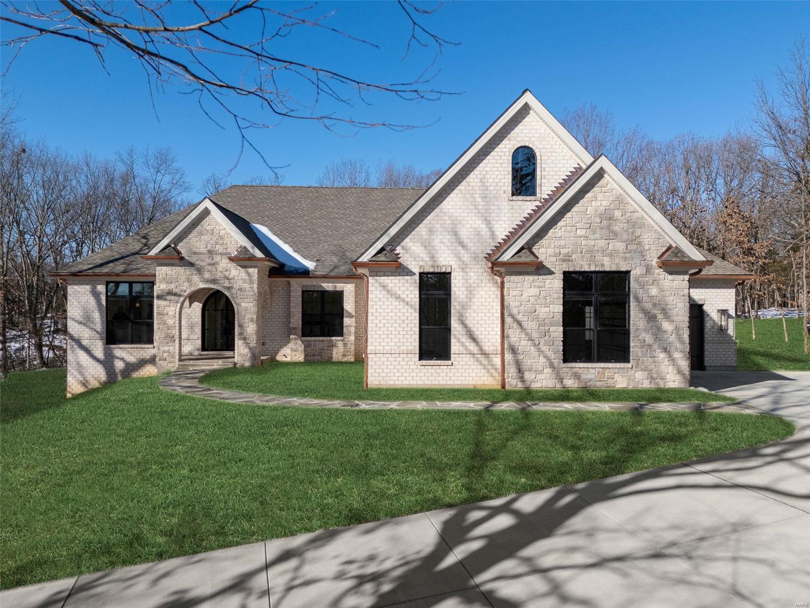Custom home on 5+ acre wooded lot. Great Room stone fireplace w gas insert flanked w built-in bookcases. Kitchen ftrs quartz counter tops, soft close cabinets w crown molding, under cabinet lighting & backsplash. Primary suite ftrs spacious bdrm w coffered ceiling, walk-in closet, luxury bath w double vanities & tiled shower. 2 additional bdrms, full bath, powder room & laundry room complete main floor. 10' ceilings throughout, engineered white oak flooring, 6 1/4" baseboards & 3 pc crown molding. Brick & stone front elevation w iron arched entry door & covered patio off Great Room. 9' basement pour. Upgrades: brick side & rear elev, cement siding, additional sq ft, private baths & walk-in closets for secondary bdrms, pool suite w bath & 2nd laundry, butler's pantry, closet systems, fiberglass windows, 8' doors, beams, trim, free-standing tub & steam shower in primary bath, upg appliances, enlarged covered patio w fireplace & kitchen, bluestone pavers, adtl bed, bath & rec in basement.