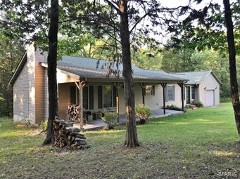 This two bedroom, one and a half bath, ranch home sits on two lots and has an additional seven lots included with property. Enjoy the solitude and wildlife on the deck or front porch.