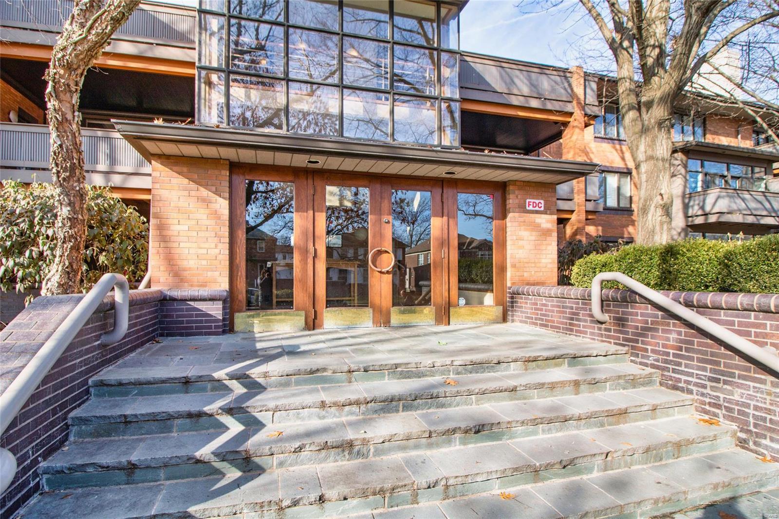 Wonderful opportunity to own a condo at The Oaks.  In the northern part of Clayton/University border, very convenient to everything. 2 beds and 2 baths with almost 1600  sf.  Large entry vestibule to condo and large entry foyer in condo itself. Master bedroom is very large with its own gas fireplace and access to the patio.  2 large closets also. Very nice , heated, 2 car garage underground accessible by elevator. Private, secure entrance. A  perfect opportunity to put your personal touches into this property. All appliances  to stay with exception of washer and dryer. Home is all electric.  Most reasonable condo fees in all of Clayton or University City. Home is being sold "as is". Owner to do no inspections or provide any warranties. Condo is listed at well under recent appraised value.  Brand new AC and furnace unit October 2022.  Entire interior (common areas) of complex will be repainted, defects patched by Certa Pro in coming weeks. Location: City, Corner Location, Ground Level