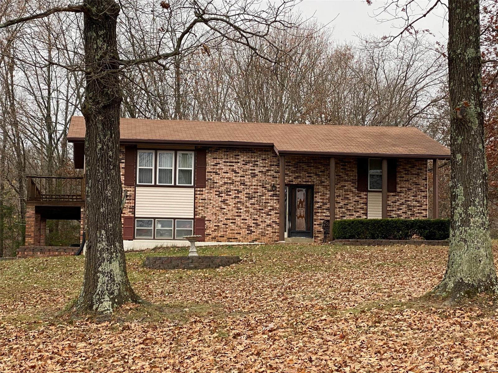 Brick front home with tuck under garage on just under 3 acres. Several updates  including new HVAC and septic system. Located just minutes from town.