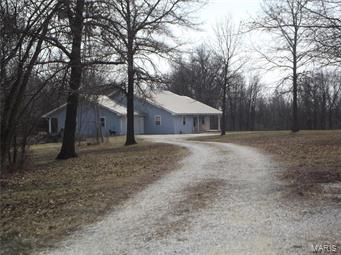 Not one to miss!! 25.9 acres outside of Paris with amazing views on the back sun room!! This home was constructed with love AND efficiency , Ground source heat pump, keep electric bills below $200 all year long. Home also boast a central vac system for easy upkeep.  Great secluded location near the Mark Twain lake for fishing, and 25.9 acres for your own wildlife enjoyment.  Recent appraisal completed.  This one story home  with 4 bedrooms and 3 baths on a walk out basement has an attached garage, and a separate 30x30 outbuilding for all of your toys and a wood stove to enjoy all year long.  Beautiful cabinetry, millwork, and walk in pantry are some of the best features.
