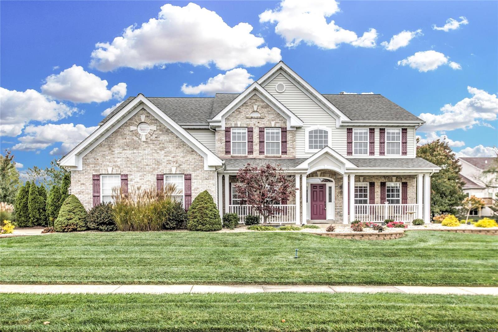 Striking 2-Story Home Near Winghaven! 2-sty entry foyer flanked by formal living & dining rms, each adorned w/detailed moldings. Expansive family rm offers bay windows, cozy gas fireplace & custom built-ins. Kitchen truly is the heart of this home, opening to generous breakfast area w/sliding door access to brick paver patio & spacious vaulted hearth rm w/TONS of natural light & 2ND gas fireplace!  Kitchen boasts a large center island w/electric cooktop + breakfast bar, abundant 42” cabinets & coordinating granite counters & LARGE pantry! Powder rm & Laundry w/extra storage polish off the 1st floor.  Luxury master suite offers His/Hers walk-in closets & huge private bath w/separate vanities, shower & large corner soaking tub!  In addition to 3 more bdrms + 2 full baths (Hall & Jack & Jill), upstairs features a 21’x15’ BONUS room that would make a phenomenal 5th bedroom! With almost a 1/2 ac. lot, outside offers plenty of green space, stunning iron fence AND 3-car, side entry garage!