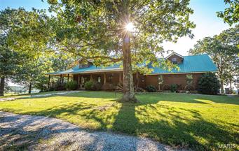 This is a one of a kind Wright County, MO combo cattle ranch &/or recreational hunting property. Complete w/fencing, cross fencing, self waterers, & 11 ponds. There's a crystal clear creek that goes through farm & is a gorgeous free flowing Ozark stream. Awesome grasses throughout w/a mix of pasture & woods w/balance of primarily hardwood timber & loaded w/deer & turkeys. Several wells on the farm & easy access throughout from country roads make this an easy farm to manage. Custom built 1.5 story log cabin home has extensive upgrades, open floor plan & is quite beautiful  throughout. Views from the wrap around porch are exhilarating. Several outbuildings & wonderful caretaker ranch hands home &/or a rental property for income. Close proximity to Springfield, MO & only minutes from Hartville, MO makes for a great location. Seller is willing to subdivide so please call agent for details regarding such. Must see & an overall great farm.