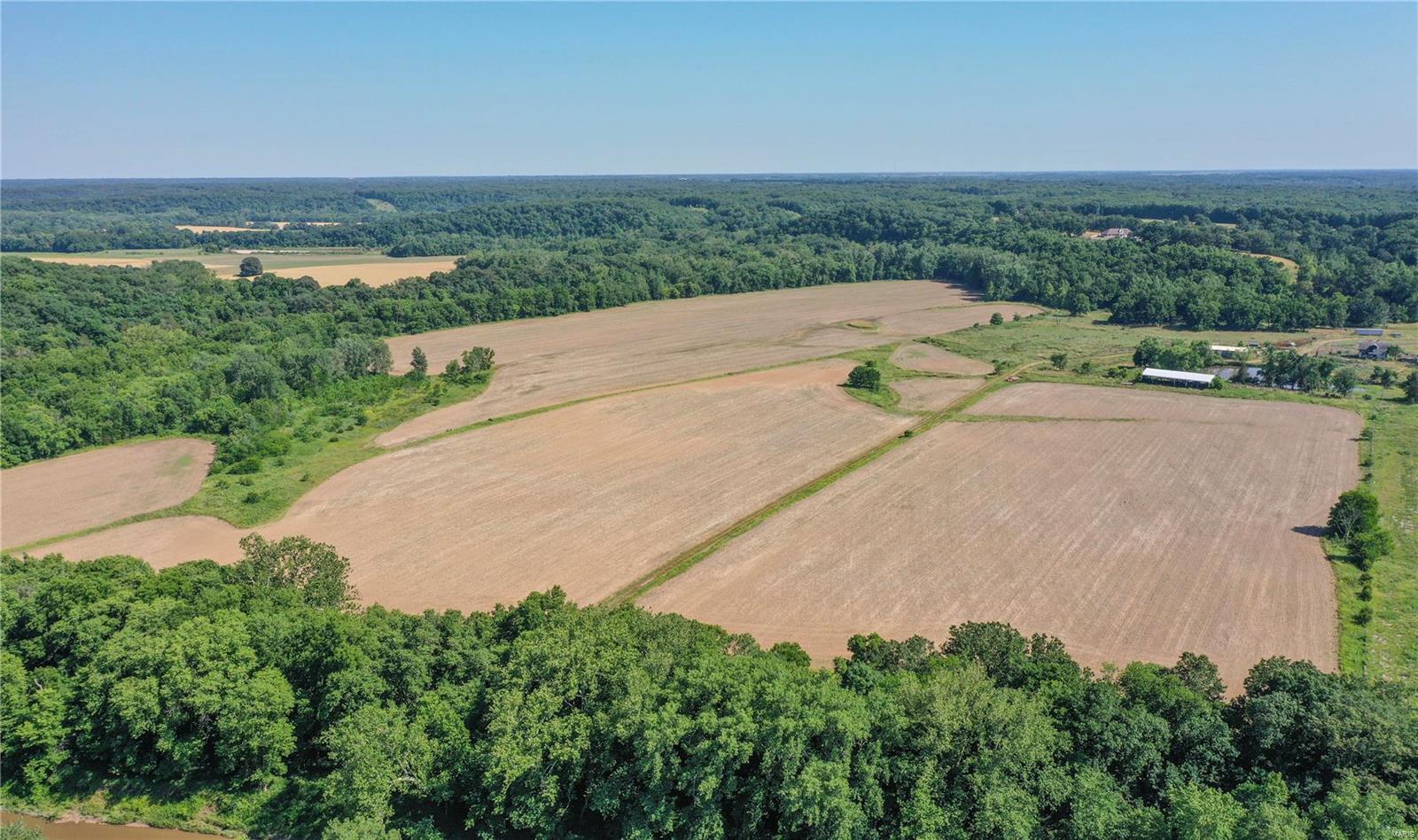 entered for comp purposes only: Stunning view overlooking bottom ground, Cuivre River. Circle drive, side-entry heated garage with bath. Surround sound throughout home, 5 speaker surround for tv. Radiant floor heating in basement, main floor & garage - 7 heating zones. Upgraded ADT security on all doors/windows/garage. Granite countertops. High-end appliances include Miele dual dishwashers, double convection ovens, 6-burner Viking gas stove, double Viking professional char-grills, custom range hood, Sub-Zero refrigerator. Foam insulation, additional R-19. Pella windows and doors. Convenient central vacuum. Massive walk-in custom pantry plus lower level walk-in cooler. Outdoor hookup for gas grill. 500 gallon propane tank plus central wood burning stove (electric backup). Soffit outlets with switch for outdoor holiday lights. Newer water heater & garbage disposal. Additional safety features include slip-resistant stairways & roof lightning rods. 332+/- acres includes multiple parcels.