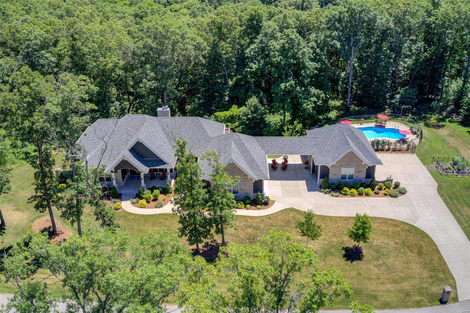 Come and tour this absolutely stunning home on 5+ beautiful acres in the Defiance area.  Close to wineries, bike trails, fishing and amazing hunting.  This 4800+ Sq Ft home boasts 10-foot ceilings on the main level and 9-foot in the lower, 2 wood burning fireplaces, 4 huge bedrooms, 3 1/2 baths, gourmet kitchen with Cambria quartz, top of the line appliances, and walk in pantry.  In the walk out basement, you will enjoy a full bar, huge wine cellar, and all the room you will need for entertaining.  For your outdoor get-togethers, a magnificent deck runs the length of the house and provides amazing views and welcome privacy. And nothing refreshes quite like the large built-in, heated, saltwater pool, with its own restroom facilities. Parking for 5 cars in two oversized garages round out this home perfectly.  You won’t find a better place to raise your family, host your friends, or just to take the edge off of a stressful day. This is the home you have been waiting for. Additional Rooms: Wine Cellar