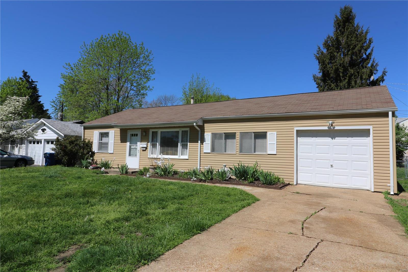 Welcome home to this lovely starter home located in the heart of St. Ann. This beautiful home has plenty of updates such as cabinetry, flooring, freshly painted throughout and professionally cleaned. Newer siding, gutters, garage door. All appliances as shown are included. Fenced in backyard with patio and children play house (this can be removed if not wanted).