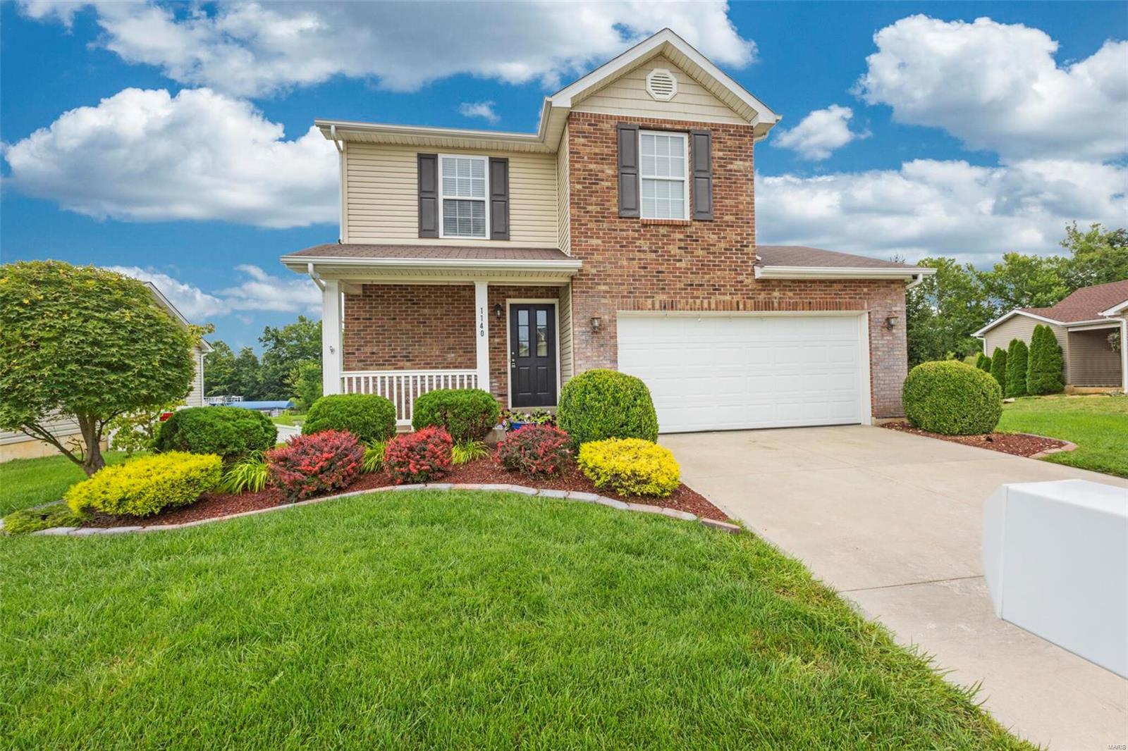 Welcome Home! This former display, 1.5 story home is ready! Settled on a great private lot backing to trees & open ground in Jaxson Estates! You will notice the great curb appeal and brand new roof as you pull into the driveway leading to the 2 car garage. Great brick and vinyl exterior for low maintenace, a covered porch and pristine landscaping! Inside, the gleaming wood floors carry through the bright great room with gas fireplace and into the breakfast room and kitchen with breakfast bar. Access the freshly stained deck that overlooks the private yard. The master suite is located on the main level with full bath and walk in closet. Main floor laundry also! Up the spindled staircase to 2 spacious bedrooms that share the hall bath. The walkout LL has some framing completed, ready for finishing to increase living space. Many updates and upgrades throughout- do no miss your chance to own this move in ready home! Please verify schools as Wentzville boundaries have changed.