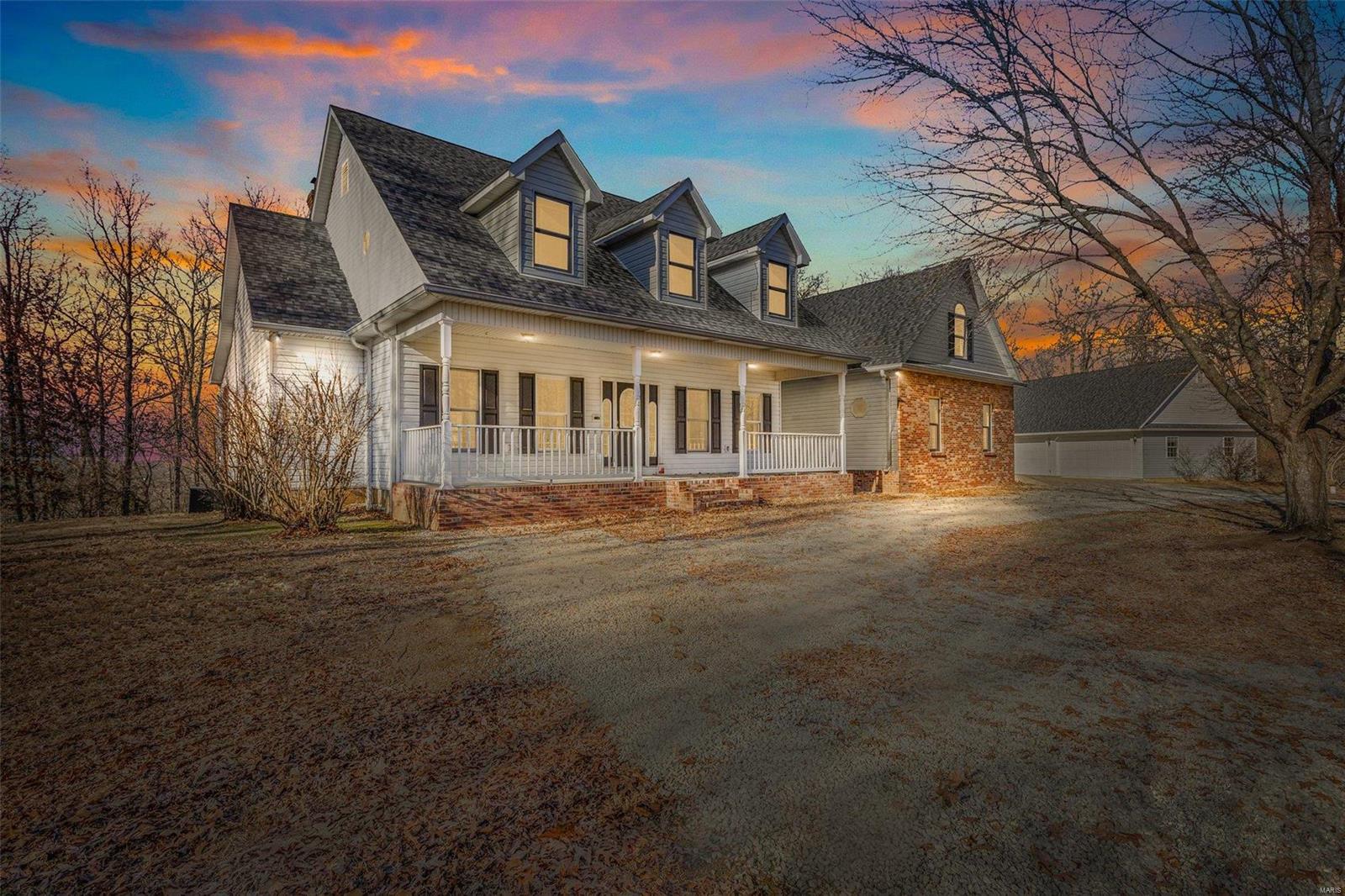A winding driveway through the trees leads to a stately custom home nestled on 65 wooded acres with access through Winchester Hills, the nicest subdivision in the Farmington MO area.  Large home has three levels, four bedrooms, and four baths.  New carpet on main level with some hardwood leads to impressive stairway to upstairs.  Large entry foyer opens to expansive views from the many windows. And so many extras, like two quaint wood stoves, several alcoves and possible 10x32 bonus room over the garage--if you need even more room!  Three car attached garage and large outbuilding with heat, air, and half bath. This beautiful property checks all the boxes and will be a dream forever home for some lucky buyer.  And--65 acres!  Must see to appreciate. This is a duplicate listing to MLS #25004598