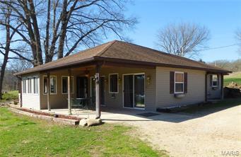 Live Where the River Runs. It's NEVER flooded!  Totally remodeled 2005 quaint cottage with 3 BR (1 w/o window), 2BA & almost 1800 SF.  Updated plumbing, siding, 30 yr. roof, electric, state of art HVAC system, windows, new baths, kitchen & more.  Living area is lined w/windows to optimize sun & river. Sliding glass doors open to covered patio. Sunny sun room & large laundry.  Guest bath w/custom tiles.  Master Suite w/tray ceiling, private tiled BA w/ jetted tub, &  walkin closet. Sliding glass doors to your private hot tub & river view. If that wasn't enough...$30,000 insulated 30 x 52' dream shop w/ 3- 10' doors, floor drains, concrete, furnace & electric.  Imagine- 177 FEET of pure river front.  Easy park like slope to river with sandy beach & large trees create the perfect set up. Landscaping. Careful....if you buy this property you'll have too many friends!  Alarm system. $149,900 on 2 acres m/l.  With adjacent rental $215,000 that rents for $500 monthly. Additional Rooms: Sun Room