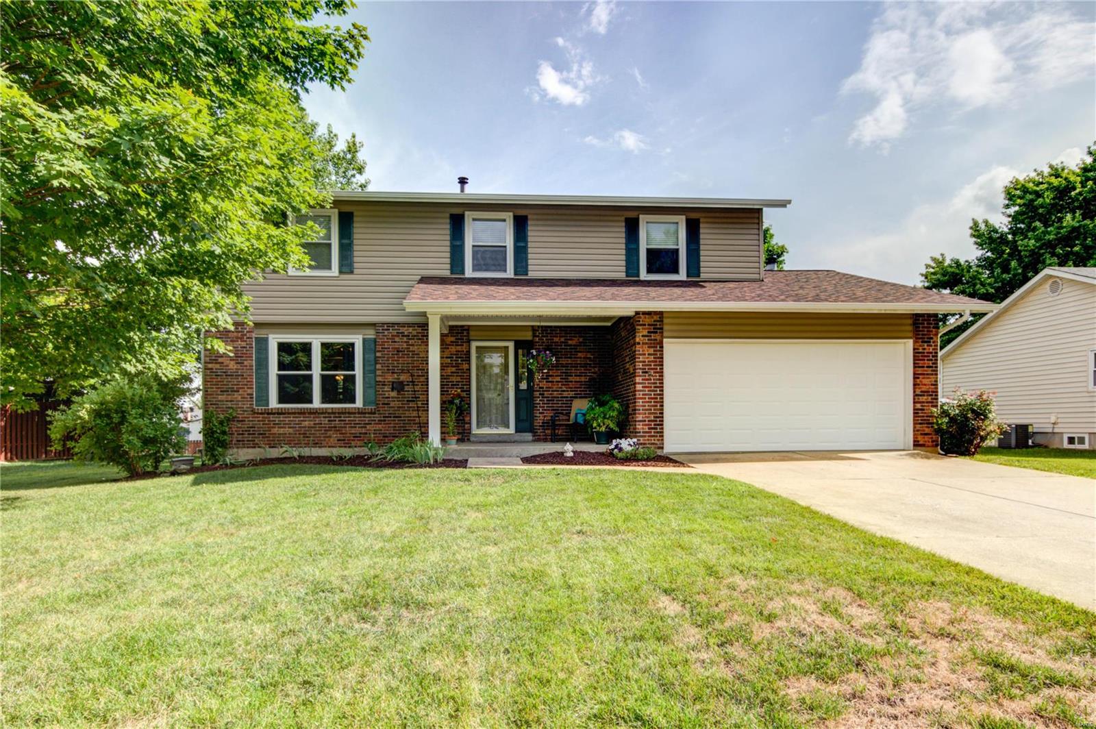 This lovely two-story home is full of updates! You'll immediately notice the curb appeal with great landscaping and a covered porch! From the foyer, the bright living room features newer laminate floors that run throughout most of the main floor! The dining room opens to the beautiful kitchen that boasts Corian counters, tons of cabinet space with organizers, stainless steel appliances, a planning desk, and a breakfast room with a bay window! Step down to the cozy family room with a woodburning fireplace. A half bath completes the main floor. In the newly carpeted upstairs, the master suite is a retreat with two walk-in closets, dual-sink vanity with marble top, and step-in shower. Three more bedrooms and a full bath round out the upper level. The basement provides plenty of space for storage! Enjoy the summer weather in the backyard shaded by trees! In a great subdivision with ponds and common areas, just moments from schools, highways, and restaurants, this could be your dream home!