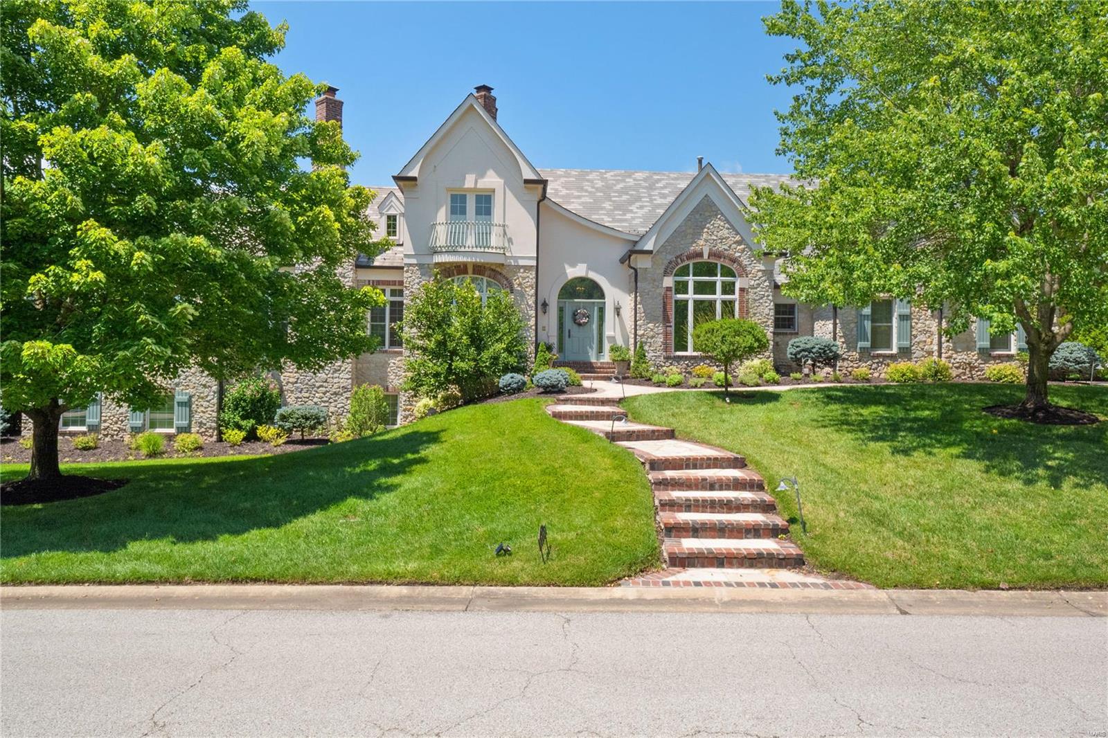Stunning stone/brick custom ranch backing to the 17th fairway of St. Albans Lewis & Clark golf course. As you enter you'll find a private study with a spiral staircase up to a private library with built-in bookcases. A generously sized dining room is perfect for gatherings. The 2 story great room features a large fireplace and built-in bookcases. A custom wall of windows, with removable stained glass, allows for ample natural light and overlooks the golf course. Beautiful kitchen with granite countertops, center island, double ovens, gas range, and opens to the breakfast room and an adjoining sunroom with French doors to the patio. Spectacular vaulted master suite with a fireplace, double walk-in closets and a luxury bath with double vanity, walk-in steam shower, and a jetted tub. Finished walk-out lower level with a rec room, walk-behind wet bar, game room, and 3 bedrooms each with a private full bath. 4 car garage, patio with fireplace, and so much more! Additional Rooms: Mud Room, Sun Room