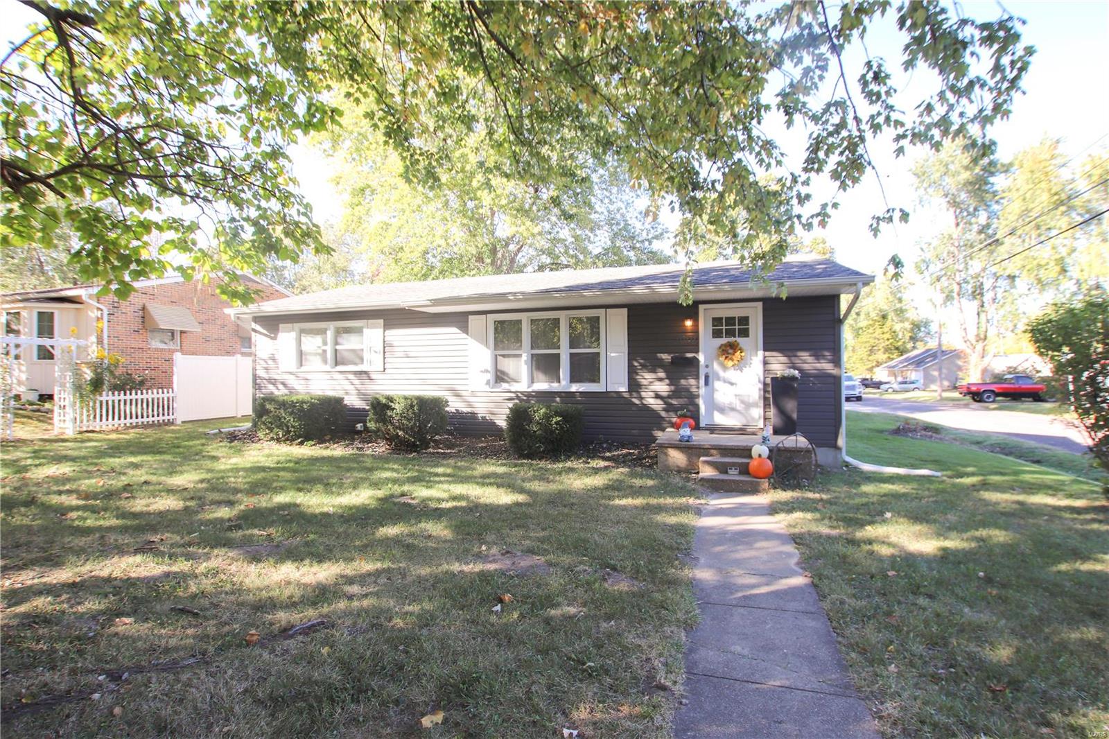 Cute 3 bedroom 2 bath home with a 2 car detached garage on great corner lot! Home has newer flooring, fresh paint, newer roof, and newer HVAC system all replaced in 2017.  Ideal set up with spacious living room located near the front of the home that leads to the updated kitchen and dining area. Home offers a half bath and main floor laundry. Home has additional unfinished space in the basement. The back door gives great access to your covered patio and backyard. The spacious garage is ideal for your car hobby, also ample parking beside garage.