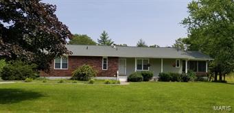 Short distance to town for all your shopping needs.  Beautiful lawn with large oak, pine & walnut trees.  Ready to move-in-condition.  Large screened-in-porch leading to the back deck.  Asphalt drive-way leading around back of the home to the two-car garage in the basement.  Large LR opens to the dining room & kitchen area for easy entertaining & family gatherings.  Large screen-in-porch for all those relaxing times.