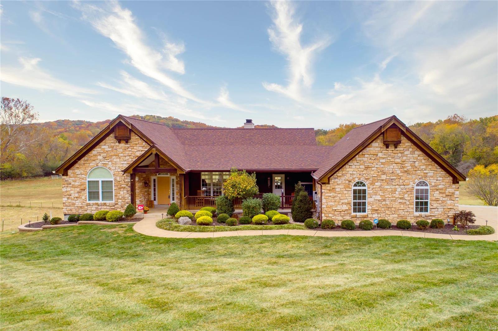 Gorgeous horse property in fantastic location! Just 2 miles from 44 and located in the AAA Rockwood School District, this 5 bedroom atrium ranch is every equestrians dream! Great curb appeal will greet you as you step onto the huge front porch. Inside you'll find hardwood floors throughout the main level, custom blinds, large kitchen with TWO walk-in pantries, main floor master and vaulted ceilings. The walkout LL has a custom wet bar and great entertaining space. Outside features two great entertaining spaces, a large deck and huge patio. The 30x56 barn has 4 stalls, tack room, large wash bay, and hay loft. Pastures are cross-fenced with 3 separate pastures, 2 auto waterers and an outdoor arena. Backs to beautiful wet weather creek. Riding distance to Rockwoods Range and Greensfelder!! New windows 2023, new roof was installed Oct 2023 and solar panels being reinstalled. Professionally painted, hardwood floors, so many upgrades to mention. See special features pages for more details!