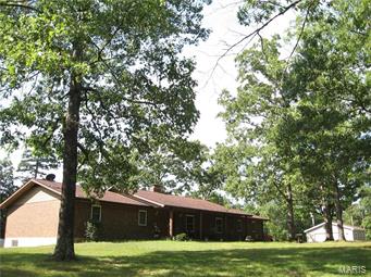 BEAUTIFUL BRICK HOME W/INGROUND POOL:
Located South of Marquand, this all brick home offers over 2,000 sq. ft. of living space on the main level with a full partially finished walkout basement. This all brick home has features that include wood, carpet and ceramic flooring, wood-burning fireplace, main floor laundry, crown molding, eat-in kitchen and a formal dinning room. The kitchen is a cooks dream with two built-in convection ovens, electric cooktop, stainless refrigerator and a built in dishwasher. The basement is partially finished and has lots of storage a sleeping room, full bath and another family room. If outside is your thing, you'll be sure to  love the in-ground pool, bath house and patio w/built-in fire pit. There is also a fenced garden area and a new detached garage/workshop area for your outdoor pleasure. All this sits on 11.38 wooded acres with highway frontage only 1.5 South of Marquand, Mo.