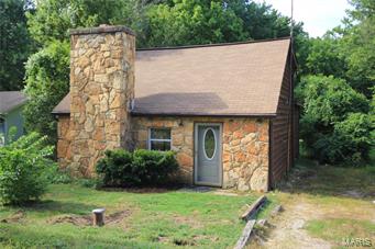 This rustic bungalow is newly remodeled and ready for you to move in. Just minutes from Pacific and I44, this charmer would make a great starter home or a peaceful weekend retreat from the hustle of the city. You enter the front door into the main living room with large stone wood burning fireplace. The large eat in kitchen has easy access to the back deck and yard for entertaining. The Master suite upstairs offers a quiet retreat after an active day in the country. The back yard has mature trees, remains unfenced, but ready for your personal touch if you so choose.  Home is not on lake, but has lake access which includes a boat ramp.