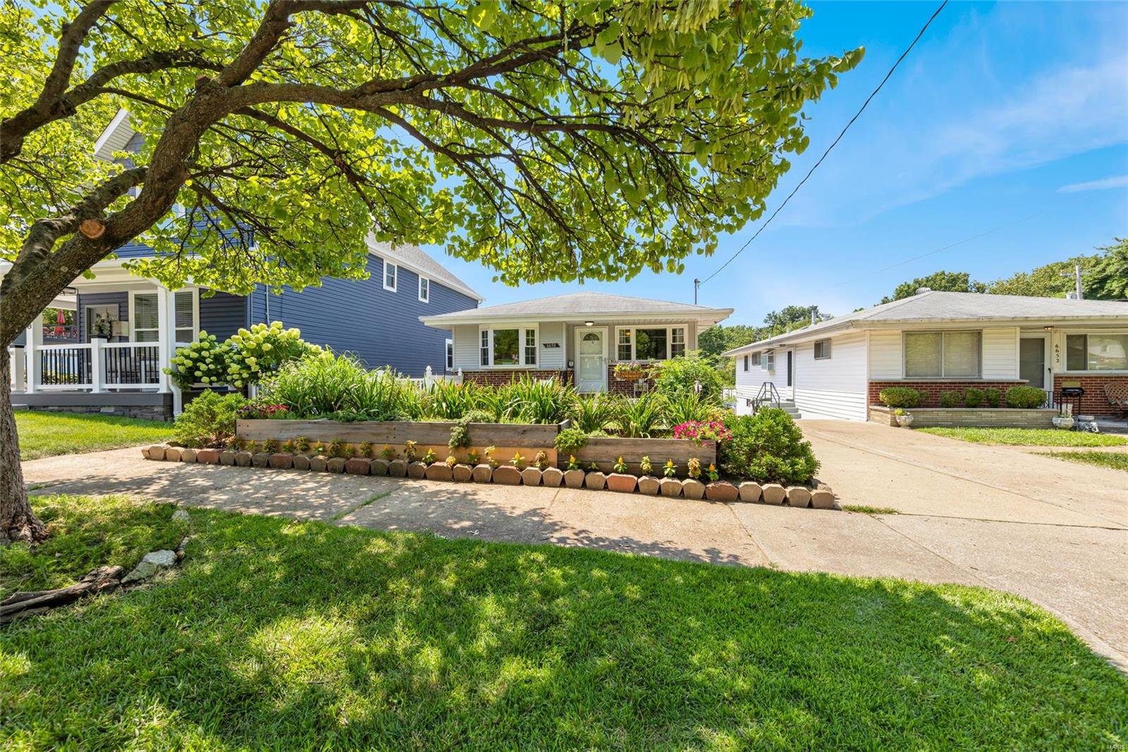 Welcome to 6650 Villa Ave in the heart of Dogtown! This charming ranch home boasts 3 beds, 2 full baths, two spacious living spaces with arched entries showing off the homes character while also inviting you to create lasting memories in it. Step into the fully updated kitchen featuring new cabinetry, pantry, stainless appliances, deep basin sink, & stunning granite countertops w/modern light fixtures illuminating your culinary adventures.The partially finished basement has a huge rec area, full bathroom, large bar and walk-out to the backyard complete w/vinyl fencing perfect for entertaining in private with gate access to the covered carport, a side walkway up to the kitchen & front yard. All while only being minutes away from dining, shopping, activities and the 5-star Forest park! Come and explore all the potential that awaits you at 6650 Villa Ave and don't miss this opportunity to embrace the Dogtown neighborhood's charm and make this lovely house your home-sweet-home.