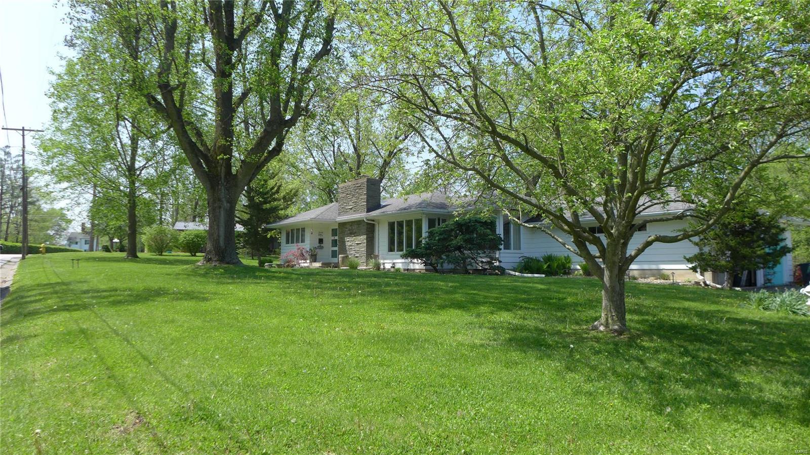 Rare opportunity to transform a beautiful 3 bedroom, 2 bath Mid-Century Modern home designed and built by Martin Construction in 1952. Located on a cul-de-sac next door to Hannibal's historic Riverview Park with 465 acres and three scenic overlooks. The home sits on a 1.36 acre lot and has large numerous windows bringing the outdoors in. Open living spaces, large stone fireplace, and hardwood floors offer a gem needing your personal touch. Sunroom looks out to a private back yard and a two level deck. Built-in bookshelves provide plenty of space for collections or your favorite books.  Oversized two car side entry garage and a partial basement provides excellent storage and location for mechanical systems. Laundry is convenient to Master bedroom. Washer/dryer will convey. Metal cabinets in kitchen are original for a 1950's look. Swinging door to dining area provides kitchen privacy. Minutes from downtown and easy access to I-72, yet nestled in a quiet, secluded neighborhood. Additional Rooms: Sun Room