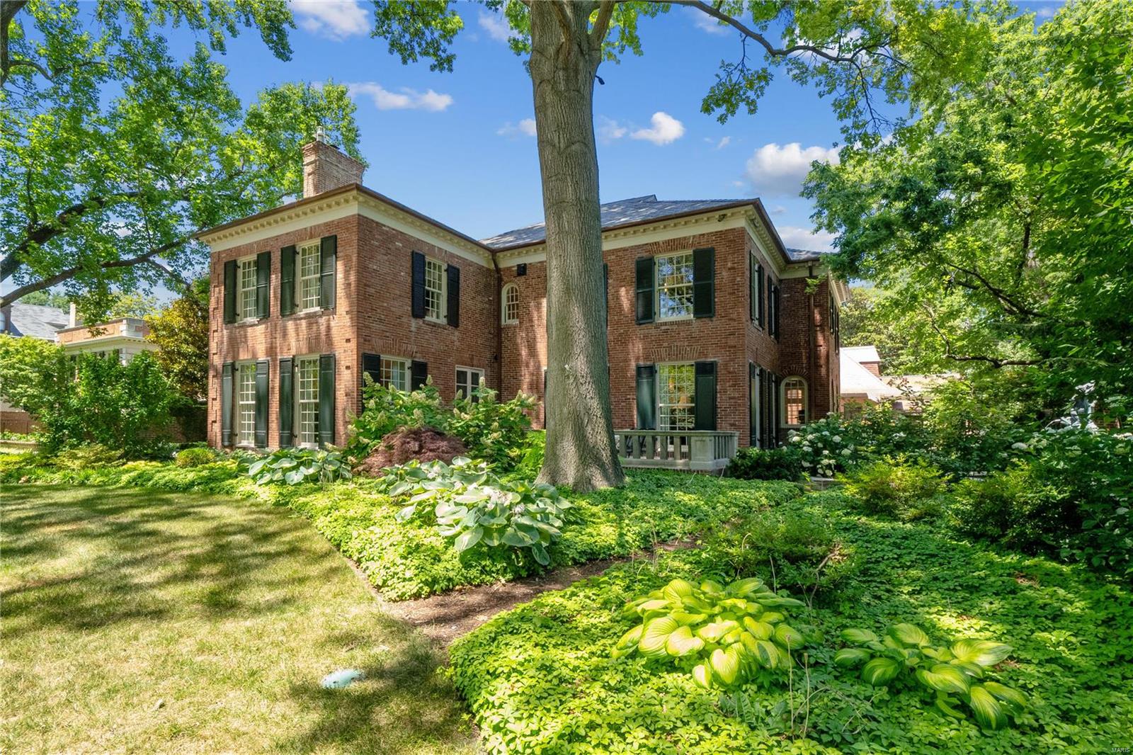 Historically significant property in the premier private community of Westmoreland & Portland Places. Over 10,000 sf of total living space. Established in 1888 as the very first residence to be built in WP/PP, the original house was replaced in 1942 with a stately Georgian Revival residence designed by renowned architect Gale Henderson. The 6000 sf, 3 bed/3 bath carriage house--the oldest structure in the community--has been re-imagined and repurposed for entertainment, recreation & living. All who enter through the massive 134 yr old sliding wood doors will be amazed that a space once used for horses & tack could be transformed into such an unforgettable entertaining and living space. Spectacular outdoor living area with salt water pool, 3 fountains & outdoor grilling area. No expense was spared in the recent renovation of the main house. Please see photo captions & video for more details about this amazing property including the antique piano that serves as kitchen center island! Additional Rooms: Sun Room, Wine Cellar