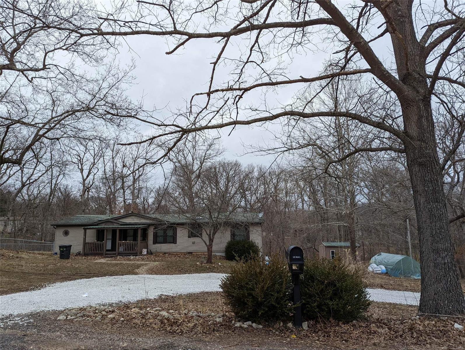 Feeling LUCKY?   Check out this perfect retreat home or full time residence, surrounded by Meramec State Park w/ private community beach & River access! This 3 bedroom, 2 bath updated ranch features an open floor plan w/ a large living room, vaulted ceilings, cozy gas fireplace & french doors leading to the huge deck/covered patio  patio furniture included!! The fully renovated kitchen features stainless steel appliances, & fresh fixtures! The spacious master has double closets & a large updated master bath w/his/her vanities, Garden tub & separate shower. The 2nd & 3rd bedroom are large w/ a divided bedroom floor plan & separate updated full bath. The mud room has room for a separate fridge complete the main floor. An outdoor nature lovers delight, this homes property features 1+ acre (8 lots) & has plenty of trees in rear yard for an abundance of privacy! Shed w/ electric, basement storage, greenhouse, & fence.  Hurry before your luck runs out!! Additional Rooms: Mud Room