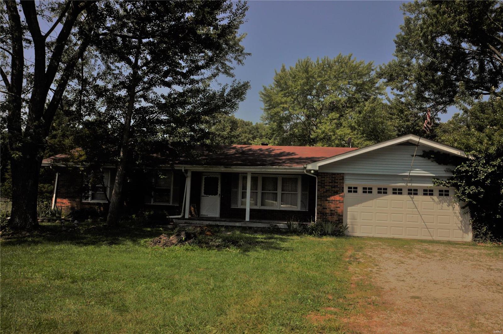 Sitting back off the road with a quiet presence is this full brick ranch home on 3.39 ac in the Defiance zip code! A diamond in the rough and a rare find at this price. 3 bedroom, 2 bath, Living room, country kitchen, family room with wood burning fireplace, 6 panel wood doors, cove ceilings, sun room to take in mother nature, walk out basement with  spacious game/rec room, wet bar for hours of entertaining, ample unfinished storage and two car oversized garage. Level lot backs to trees. This is a fixer upper that needs paint and some TLC. Bring your tools, elbow grease and ideas. Septic system is to current St Charles County code, county water, Francis Howell Schools. Property to be sold "as is". No showings until Friday, 7/30-Open House Sunday 12-2pm.j Additional Rooms: Sun Room