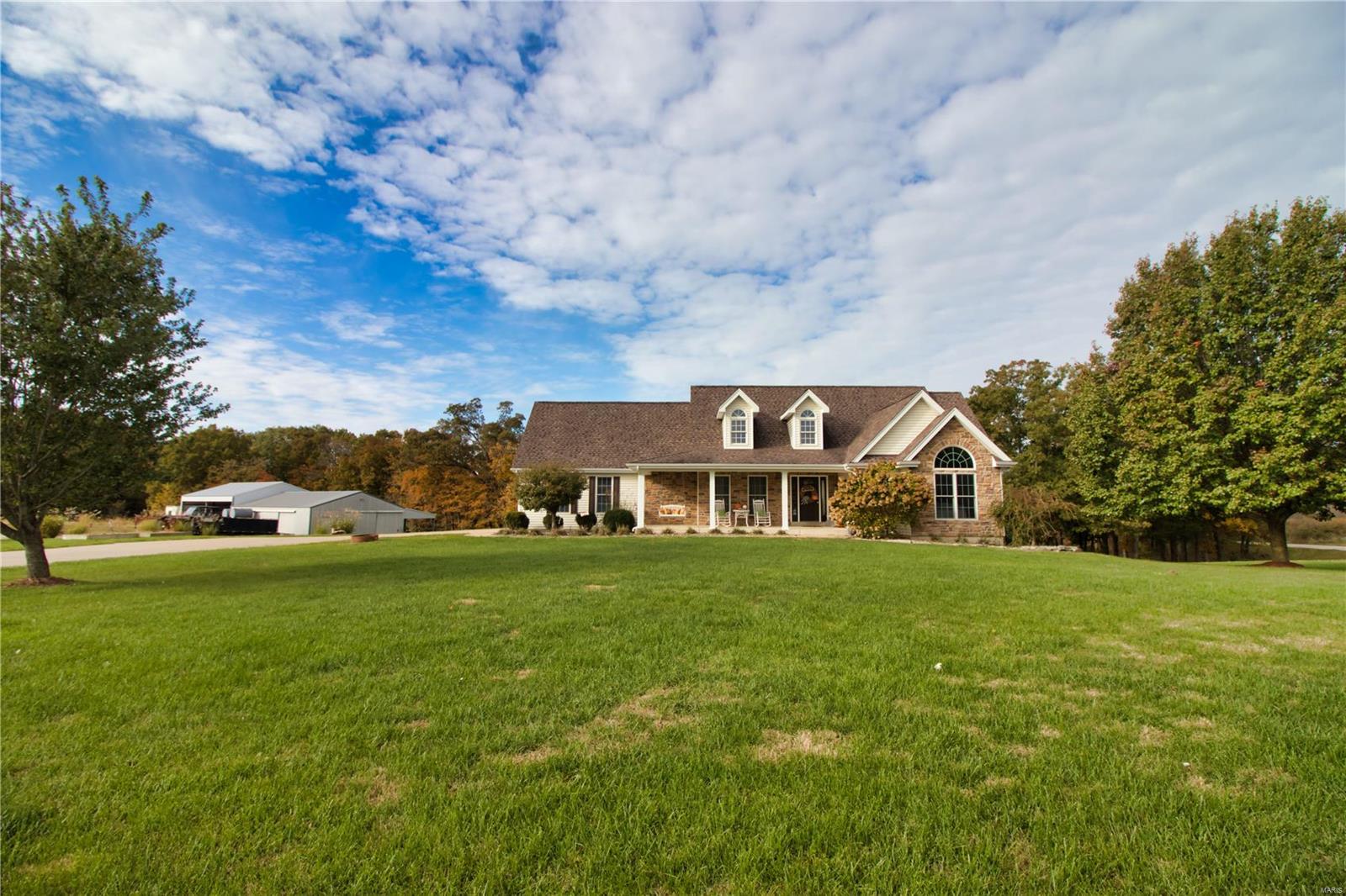 **Highest & best by 5pm 11/27 no escalation clause** Fantastic does not even begin to describe this home overlooking a 1/2+ acre stocked lake on 8.7 acres.  Vaulted great rm w/floor-to-ceiling stone fireplace, fabulous reclaimed Barn wood floors spanning most of the main floor, The kitchen is to die for w/10 ft ceilings & crown molding, center island w/massive leathered granite slab, 42” cstm cabinets & backsplash, floor to ceiling windows in the hearth rm W/additional stone FP & dining rm that leads to the 26 x 16 covered porch w/Trex decking, & is wired for TV, Vaulted master suite w/massive walk-in closet, luxury bath w/jetted tub & separate shower & an adjoining bedroom that is being used as a closet. The lower level is set up for an entire additional family w/a full kitchen, family rm, dining rm, 2 baths, laundry rm, massive Rec room w/wet bar & walks out to the patio.  Other features include a 36 x 48 detached garage w/concrete electric & 1/2 bath w/a 36 x 38& 86 x 12  lean-to’s!
