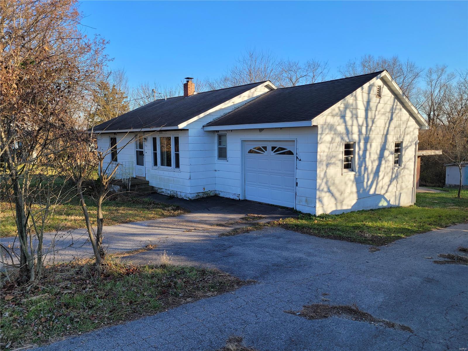 Looking for a place in town where you can still have your horses or your Pony. Nice little two possible 3 bedroom home in Bourbon with large lot, huge barn and extra attached outbuilding. Many possibilities including home based business here. Large gorgeous Sunroom with walkout to a large wood deck for entertaining. Attached garage, Large basement could be finished for more living space. Easy parking with a circle drive. Home needs some updating but is very livable as is while you make it your own. Unique opportunity in town with the lot and barn. Additional Rooms: Sun Room